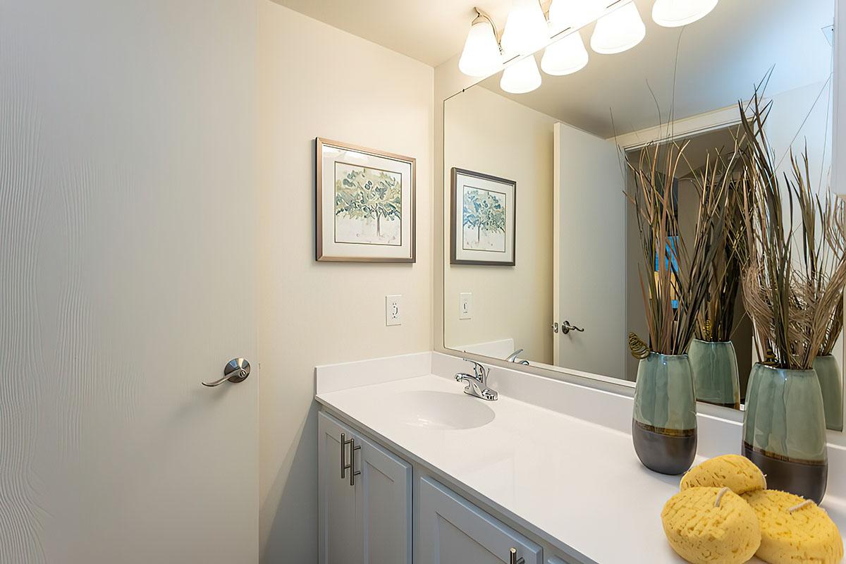 a room with a sink and a mirror