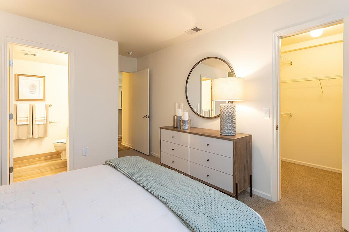 a bedroom with a bed and a mirror