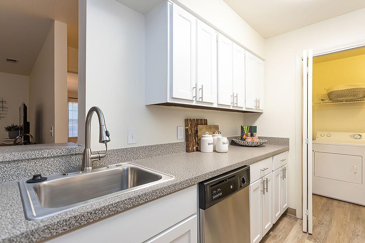 a kitchen with a sink and a mirror