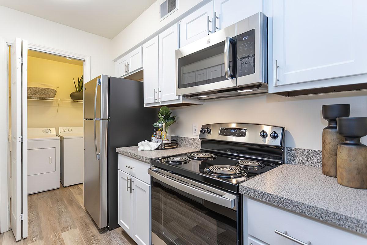 a stove top oven sitting inside of a kitchen