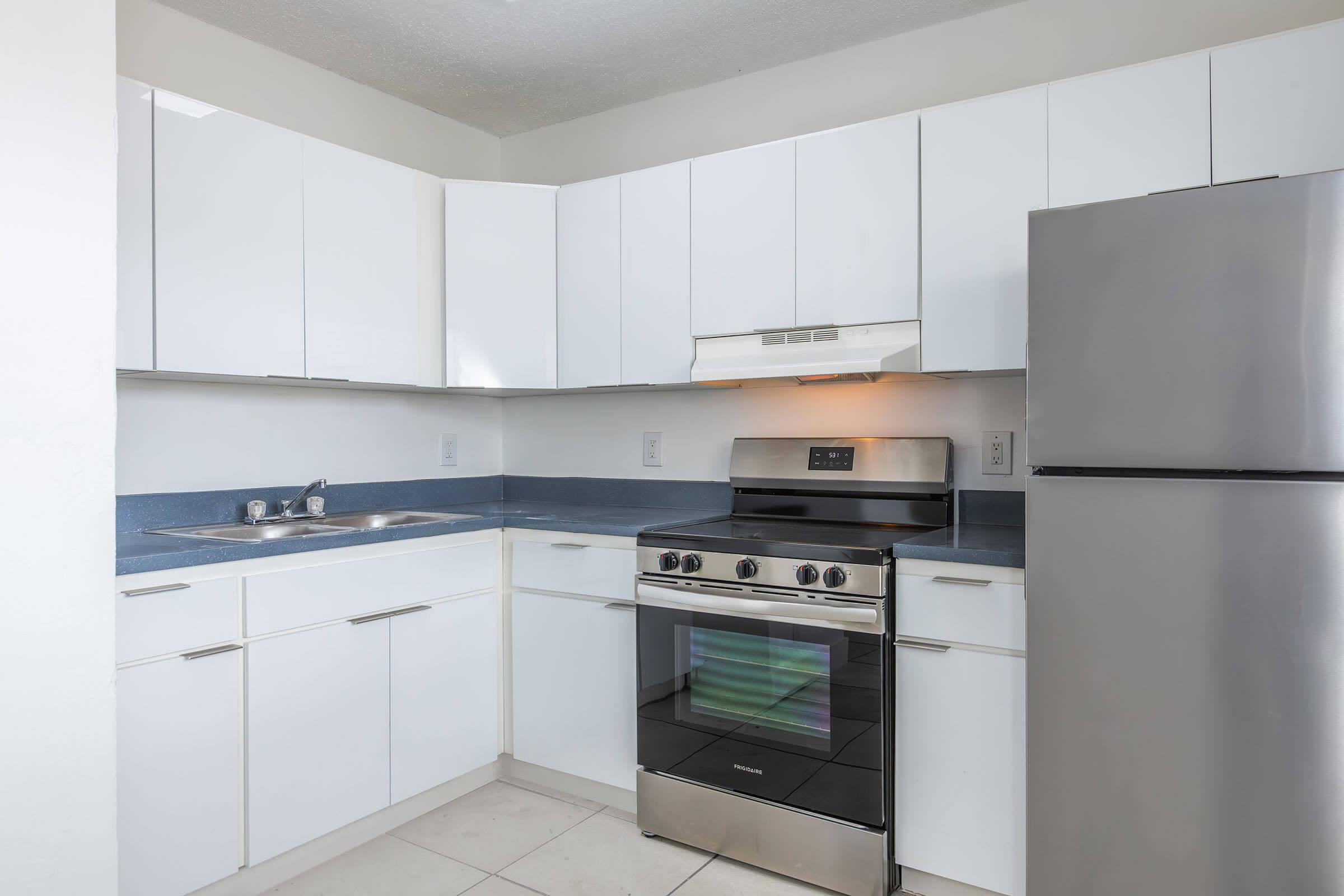 a kitchen with a stove top oven sitting inside of a refrigerator