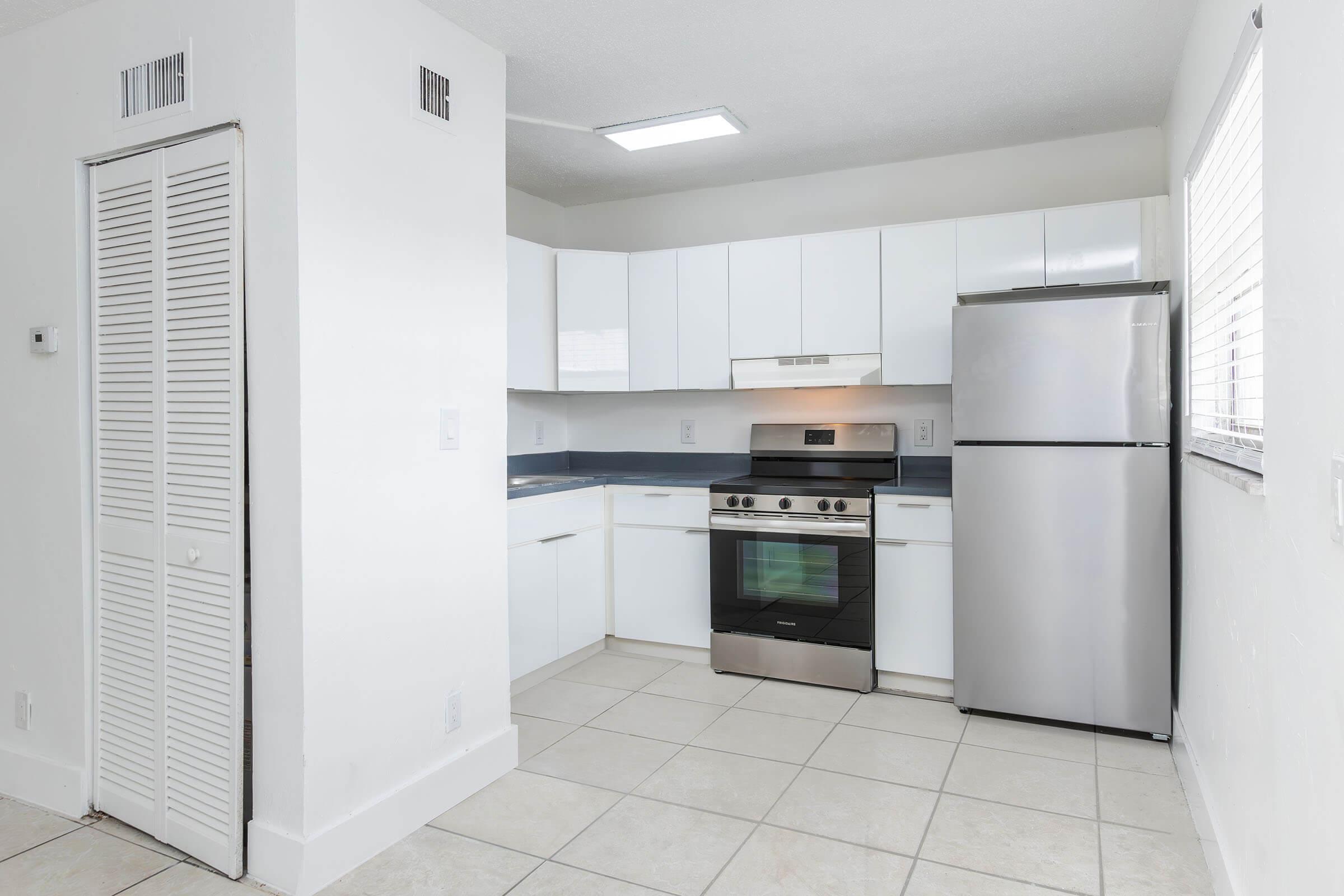 a kitchen with a stove and a refrigerator