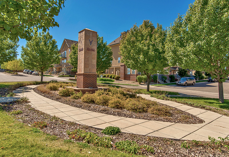 a path with trees on the side of a building