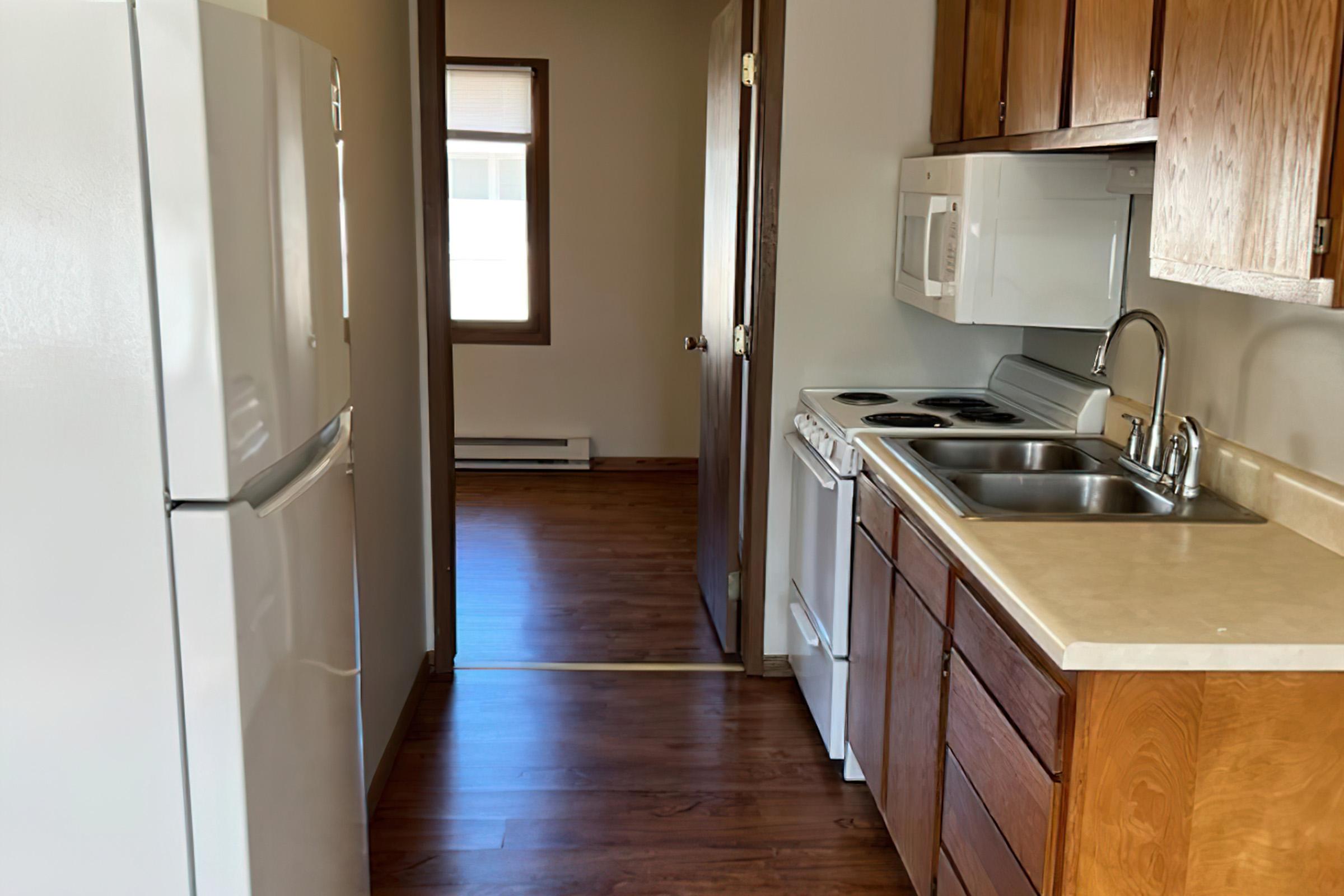 a kitchen with stainless steel appliances and wooden cabinets