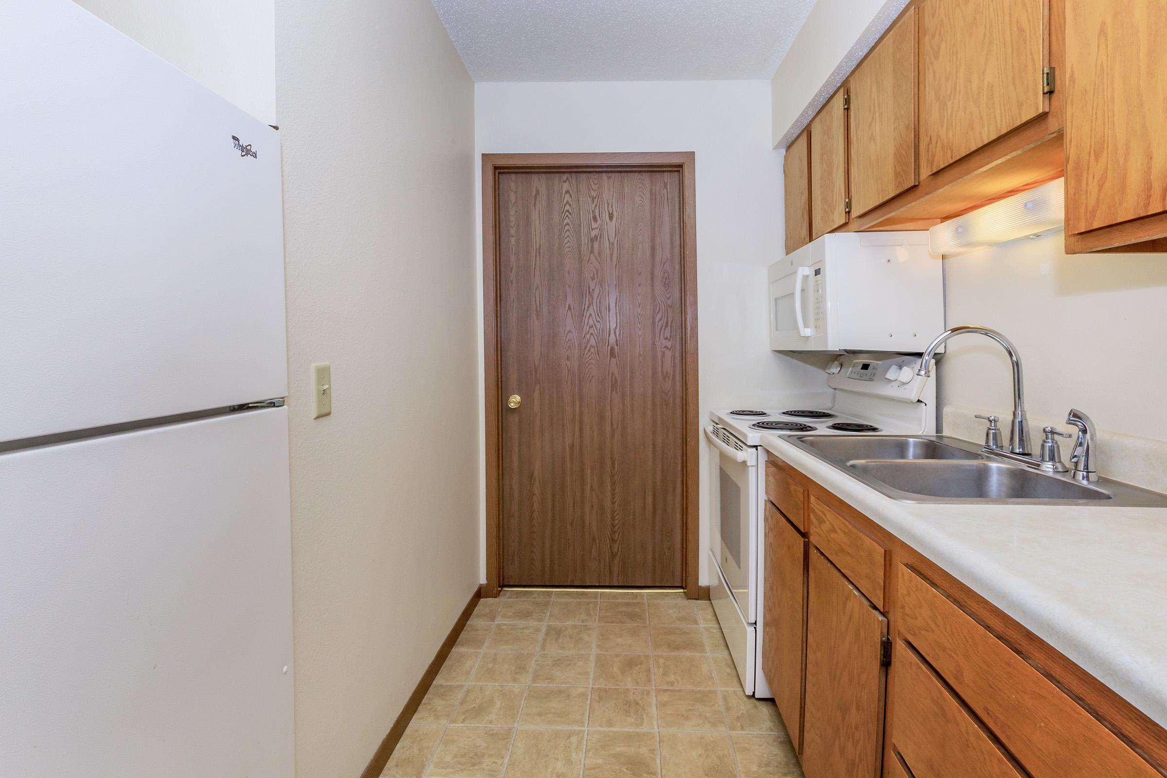 a kitchen with a sink and a refrigerator