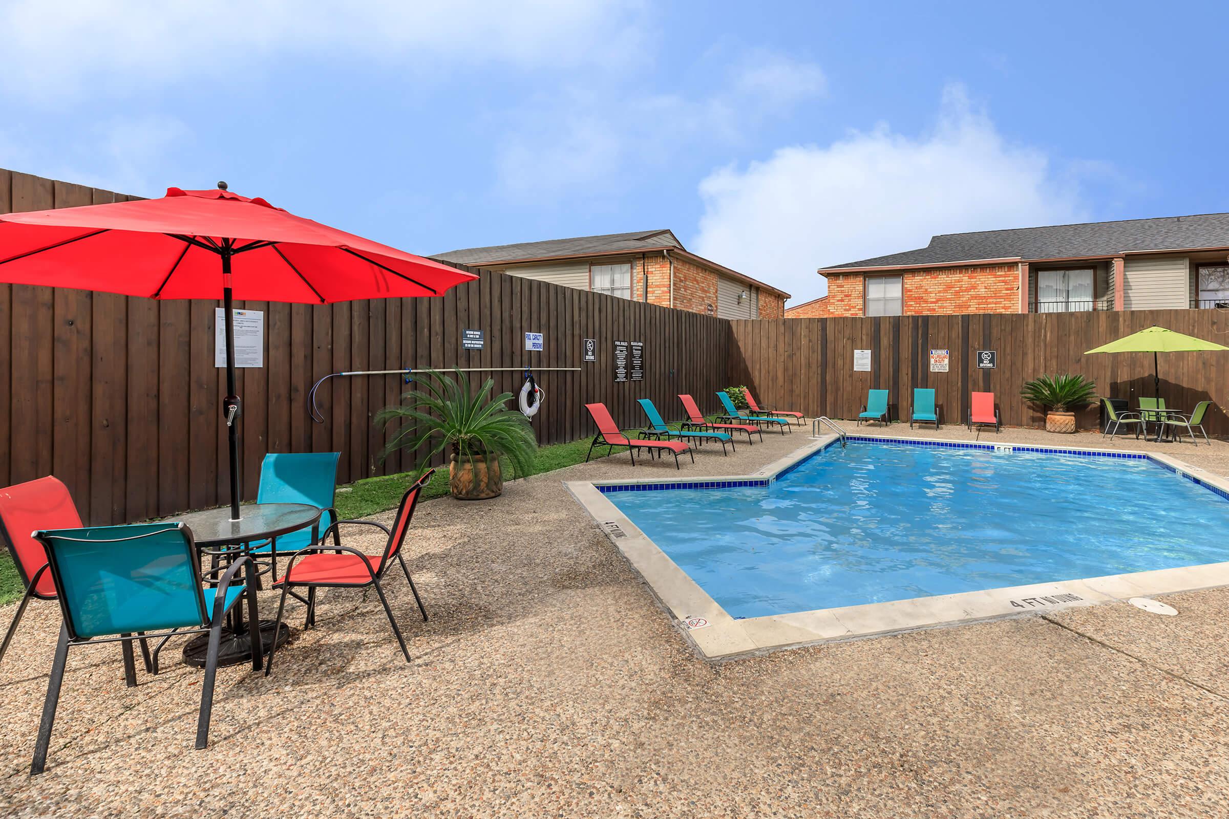 a house on a beach in front of a pool of water