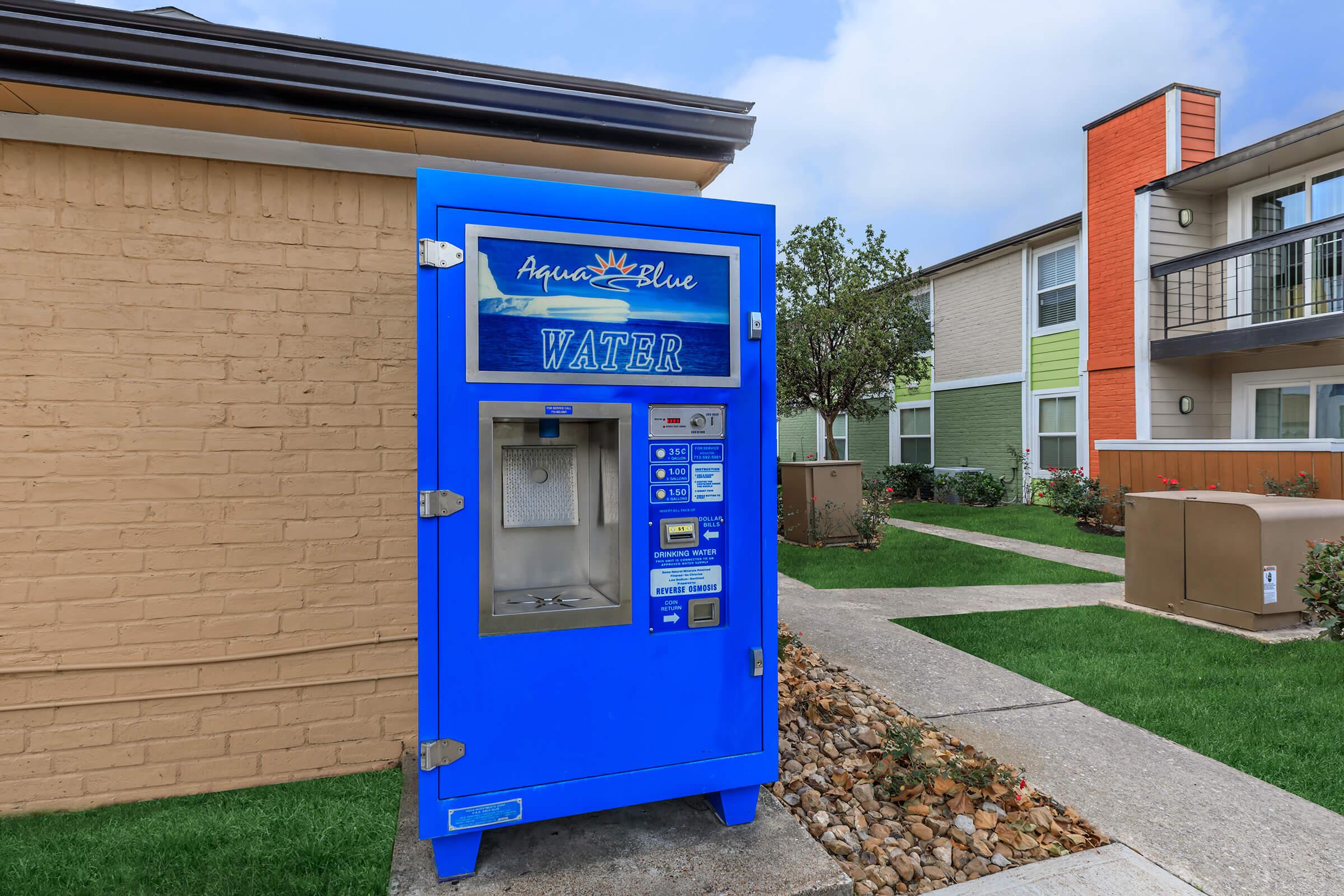 a parking meter sitting on the side of a building