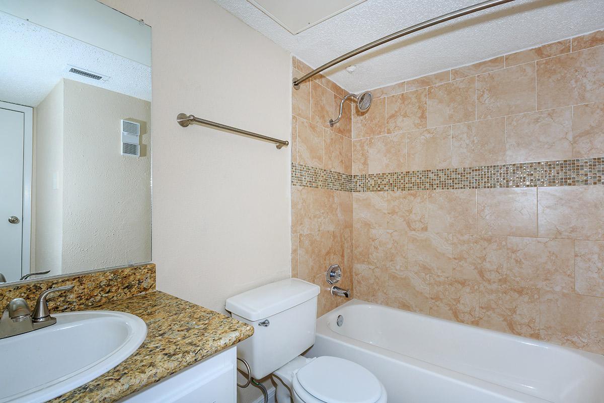 a white tub sitting next to a sink