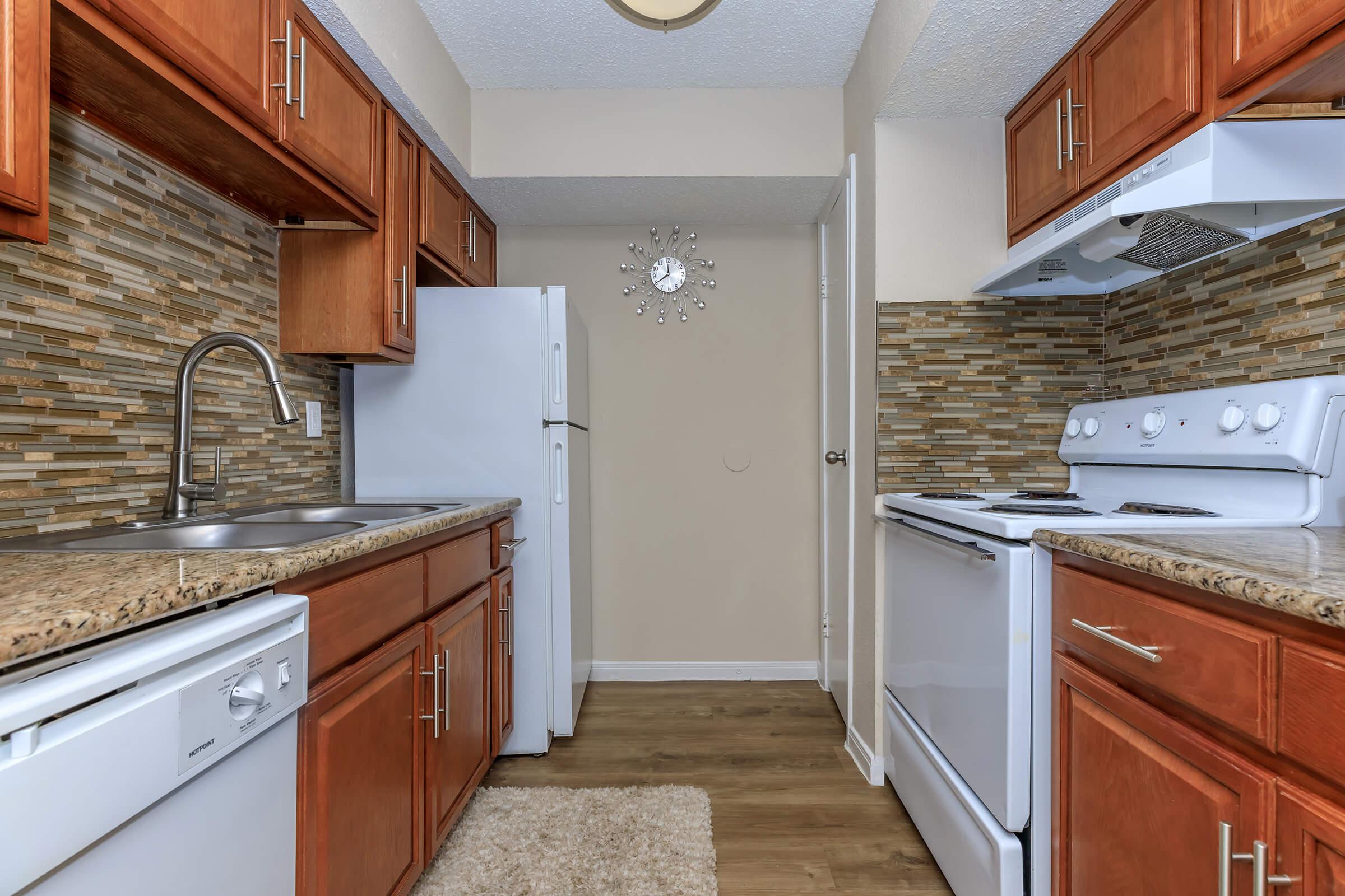 a kitchen with a stove sink and refrigerator