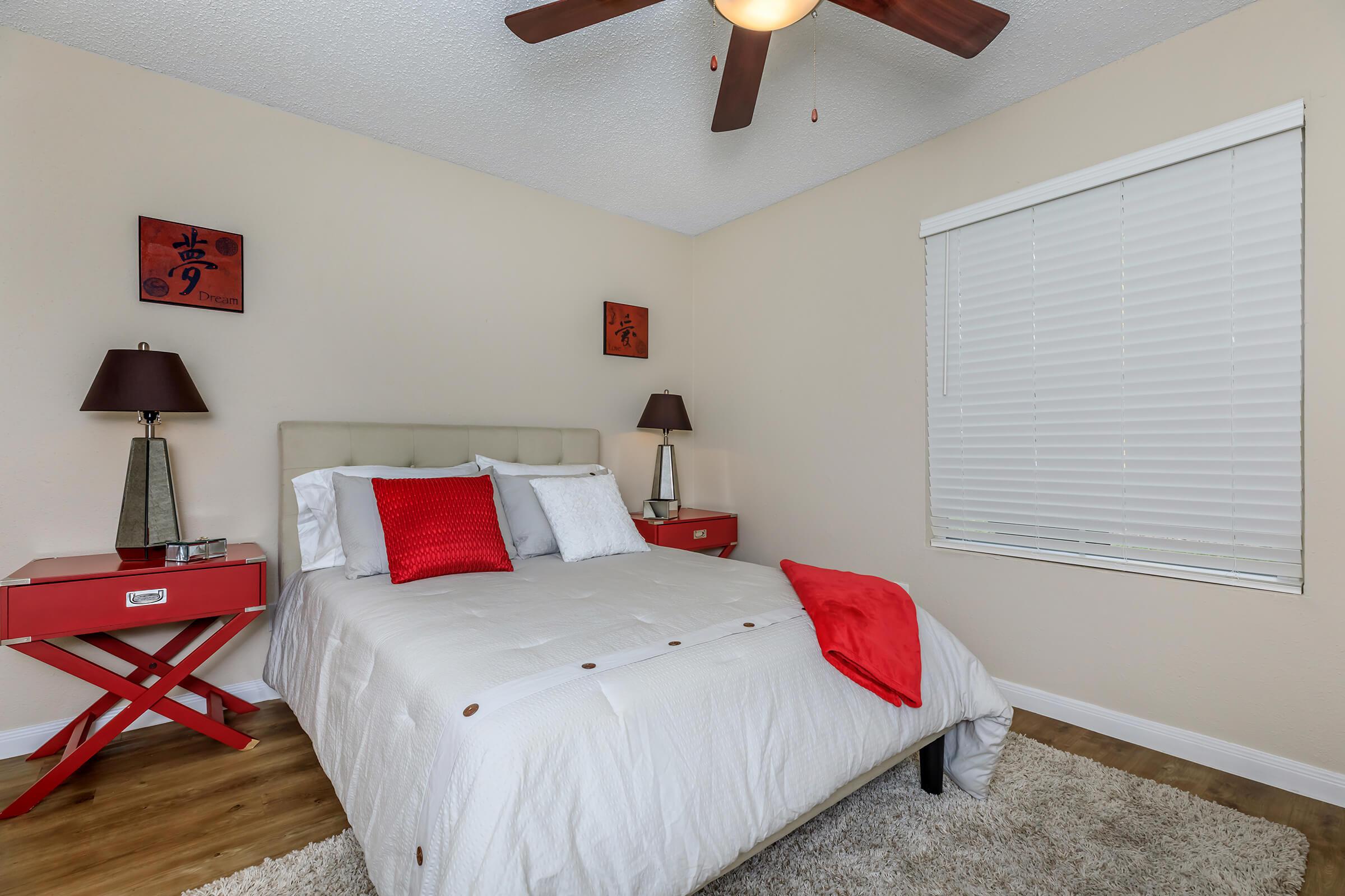 a bedroom with a bed and desk in a room