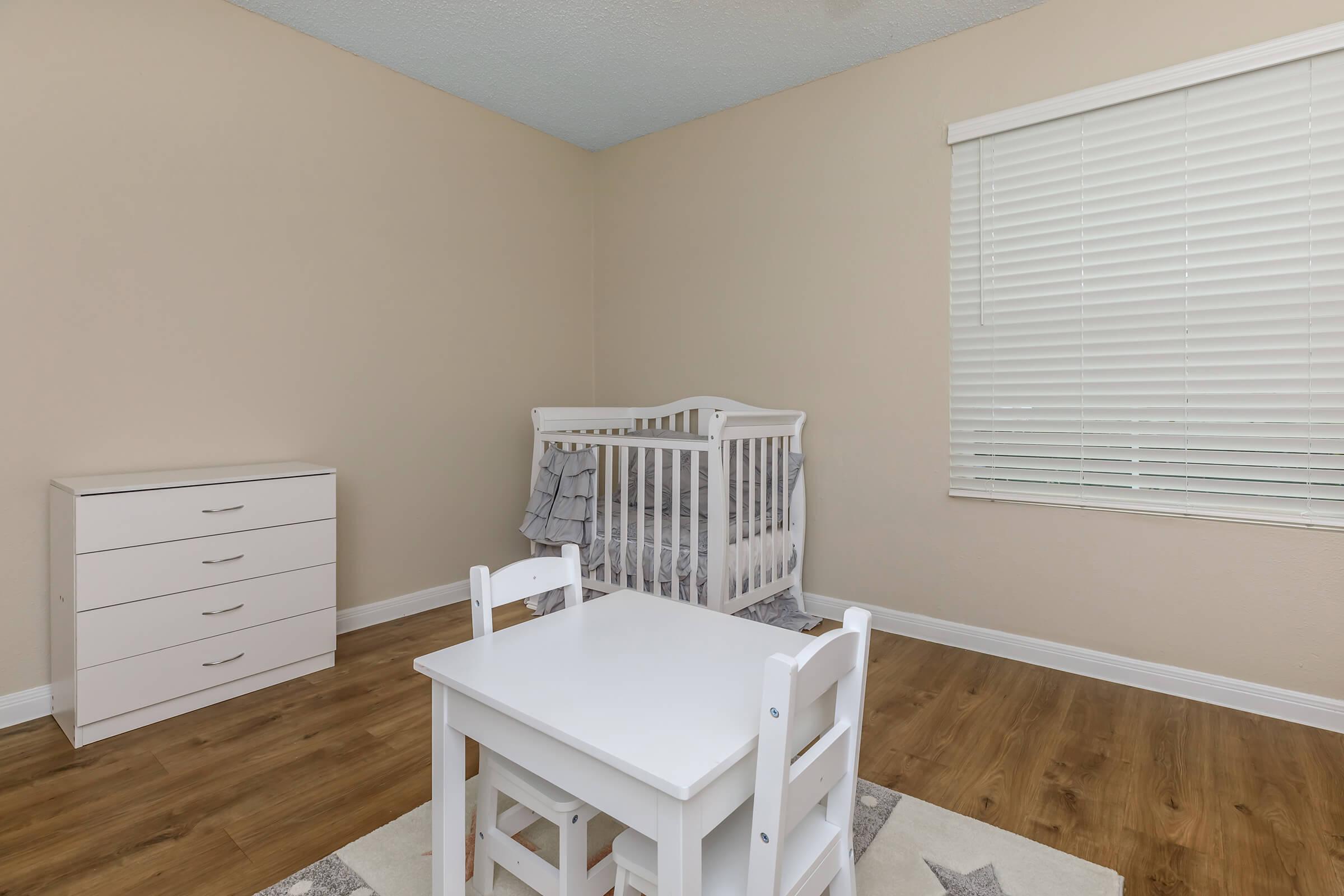 a bedroom with a bed and a chair in a room