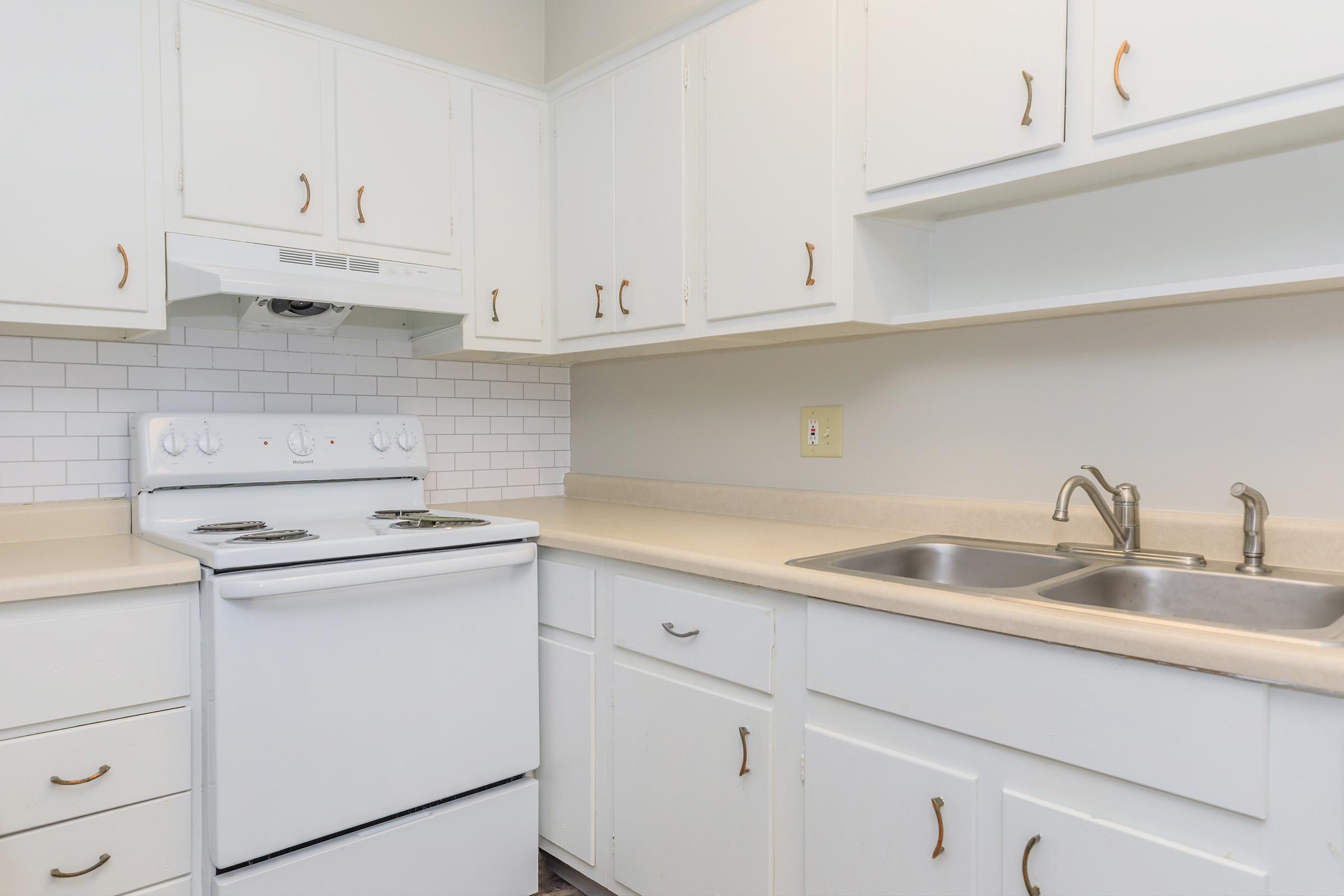 a stove top oven sitting inside of a kitchen