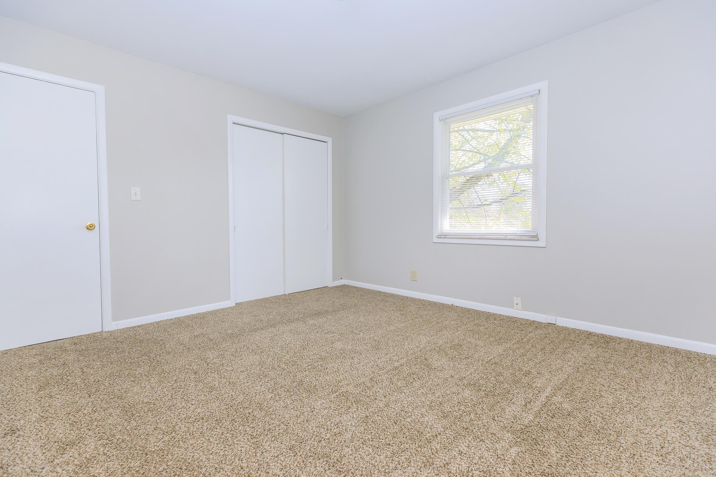 a bedroom with a large window