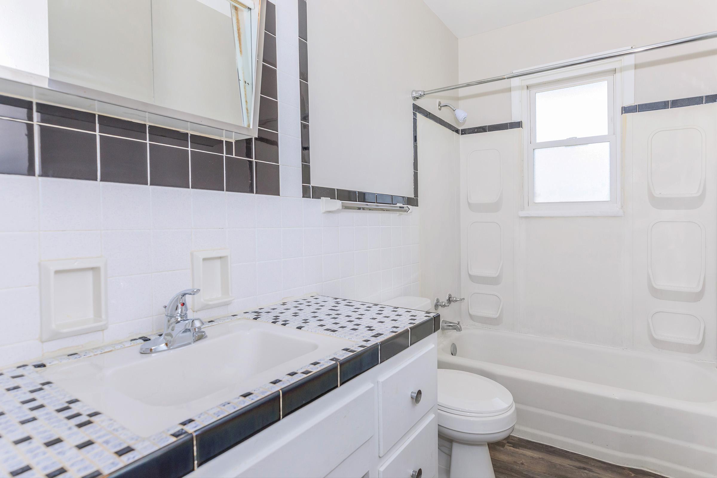 a kitchen with a sink and a mirror