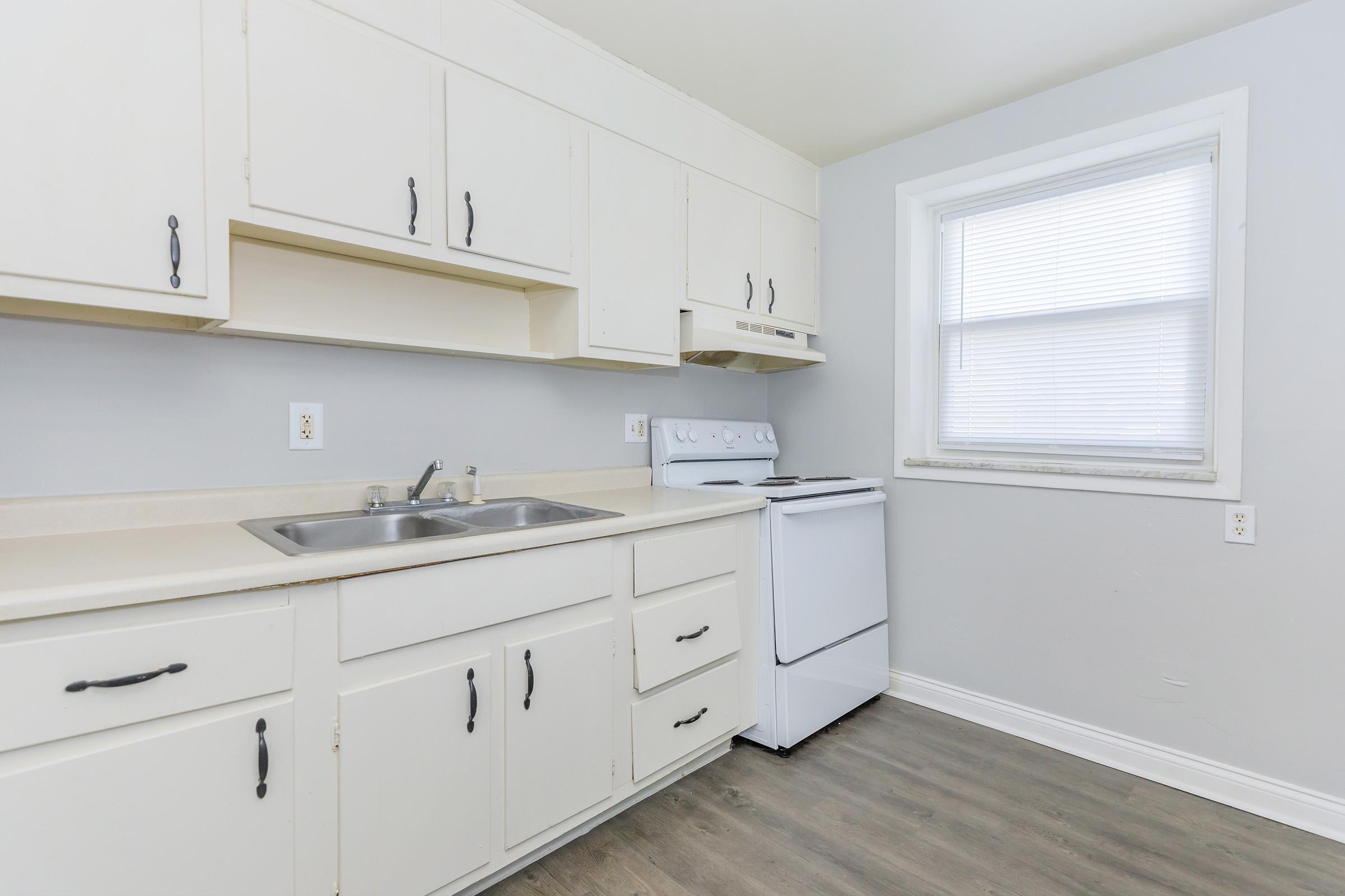 a kitchen with a sink and a window