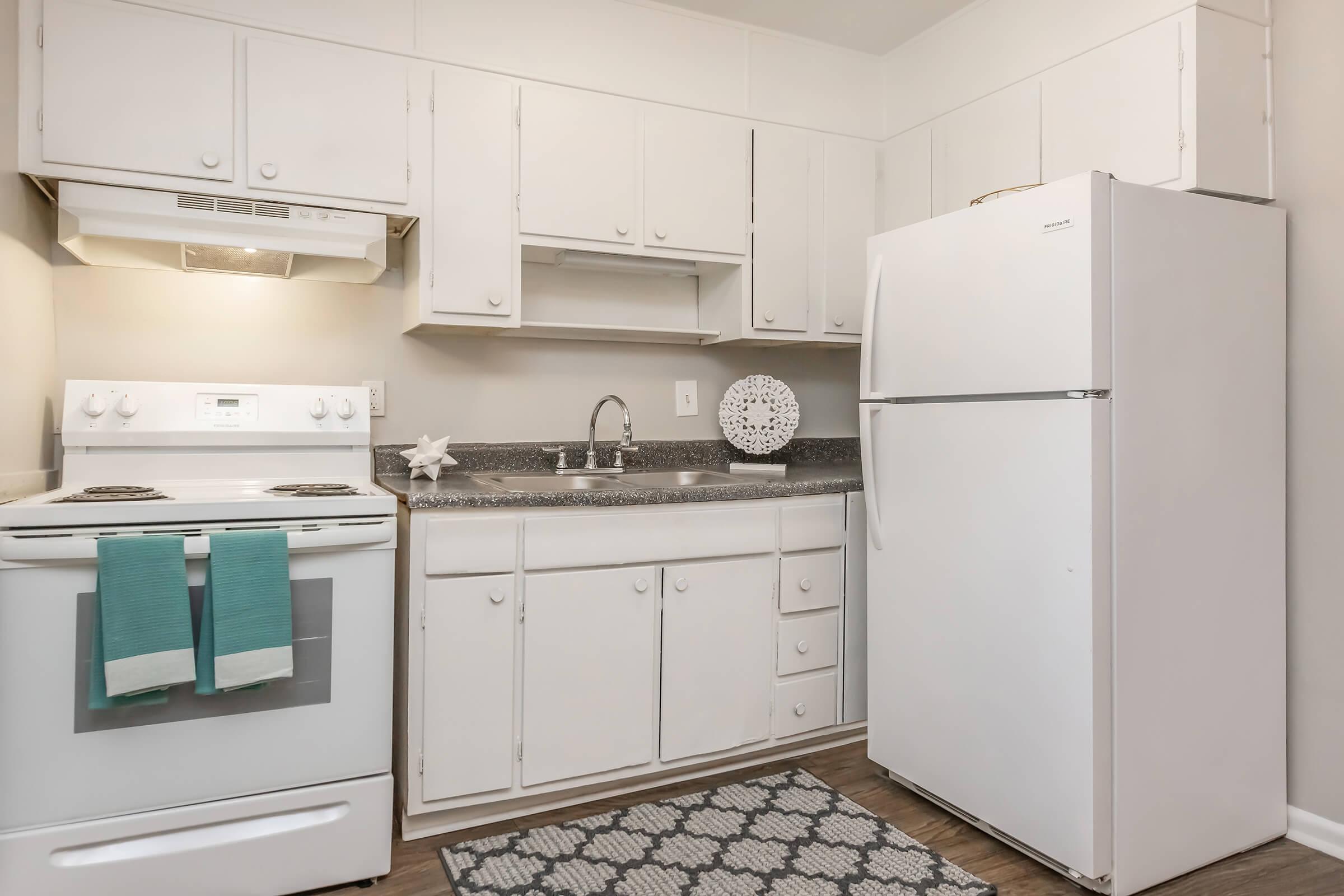 a kitchen with a stove and a refrigerator