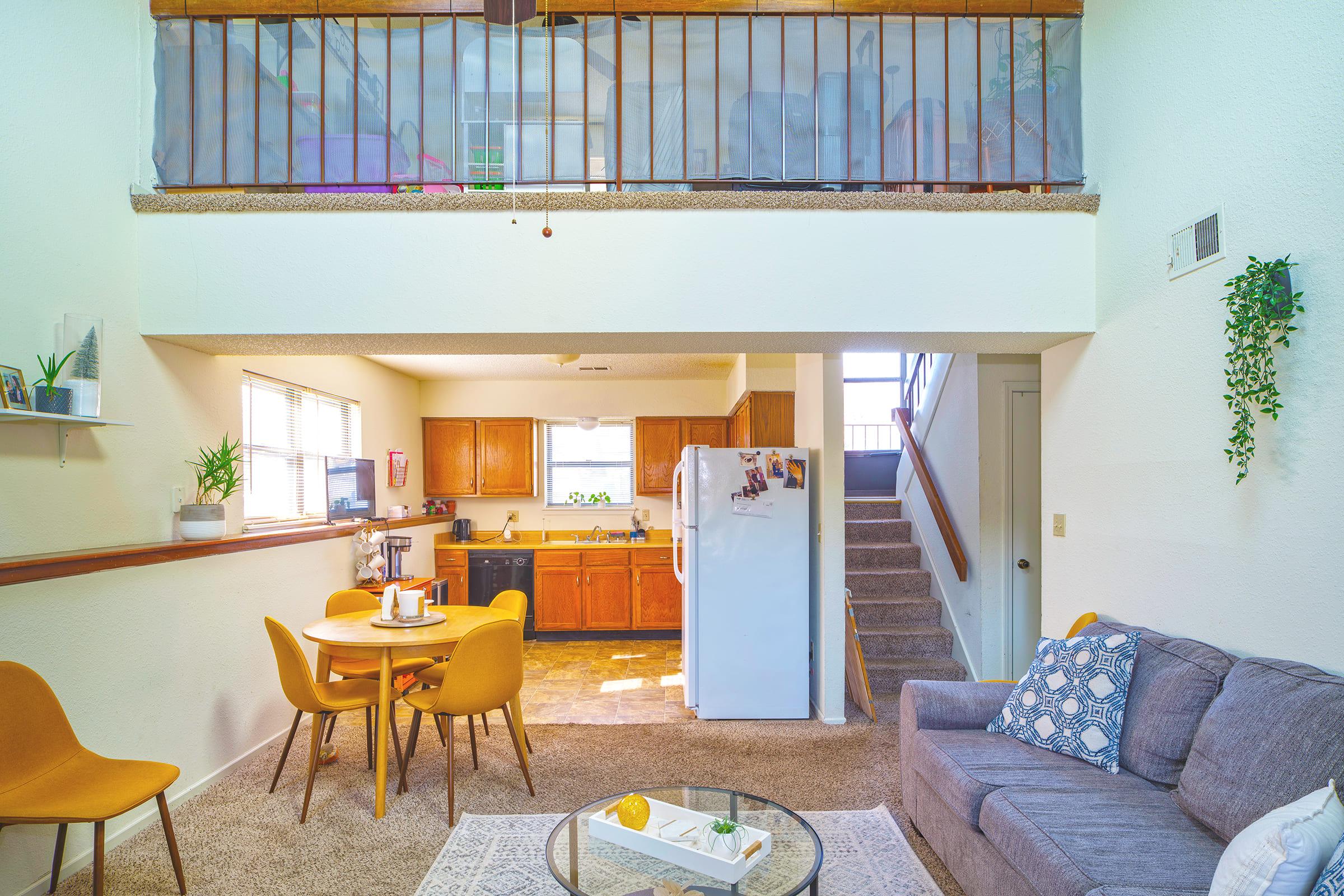 a living room filled with furniture and a large window