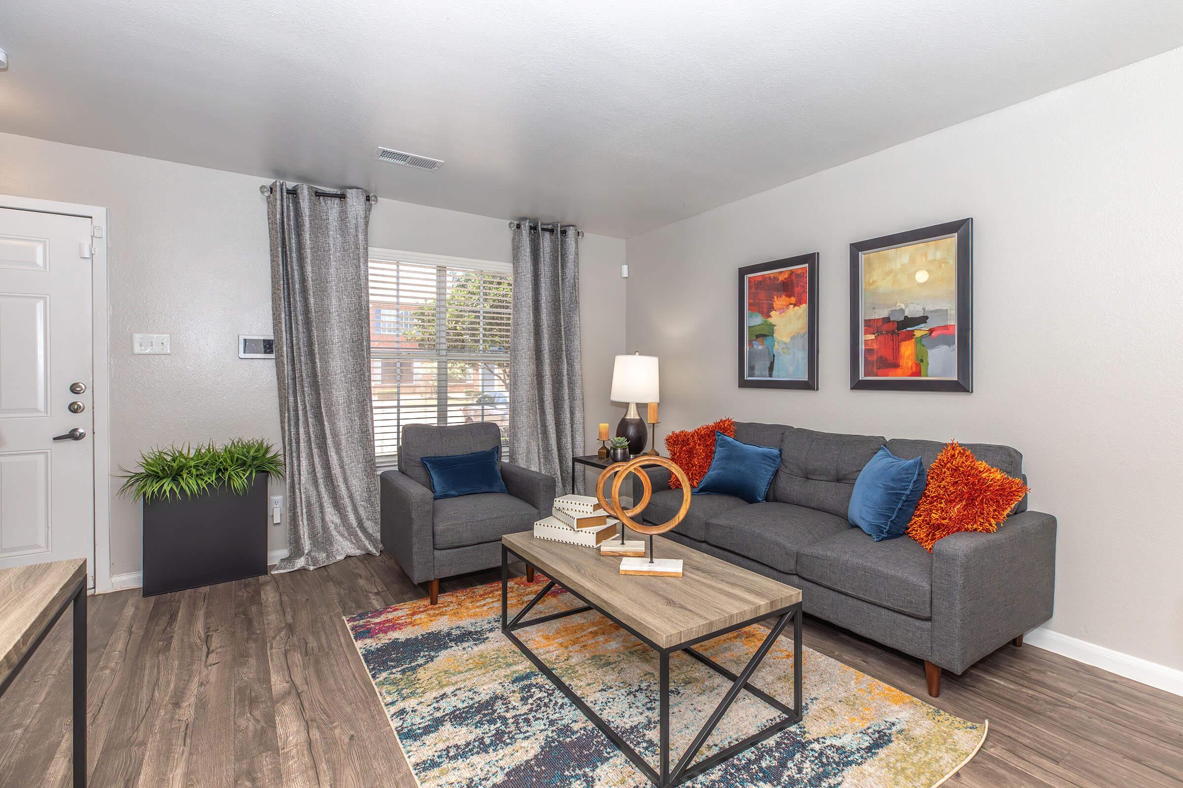 a living room filled with furniture and a large window