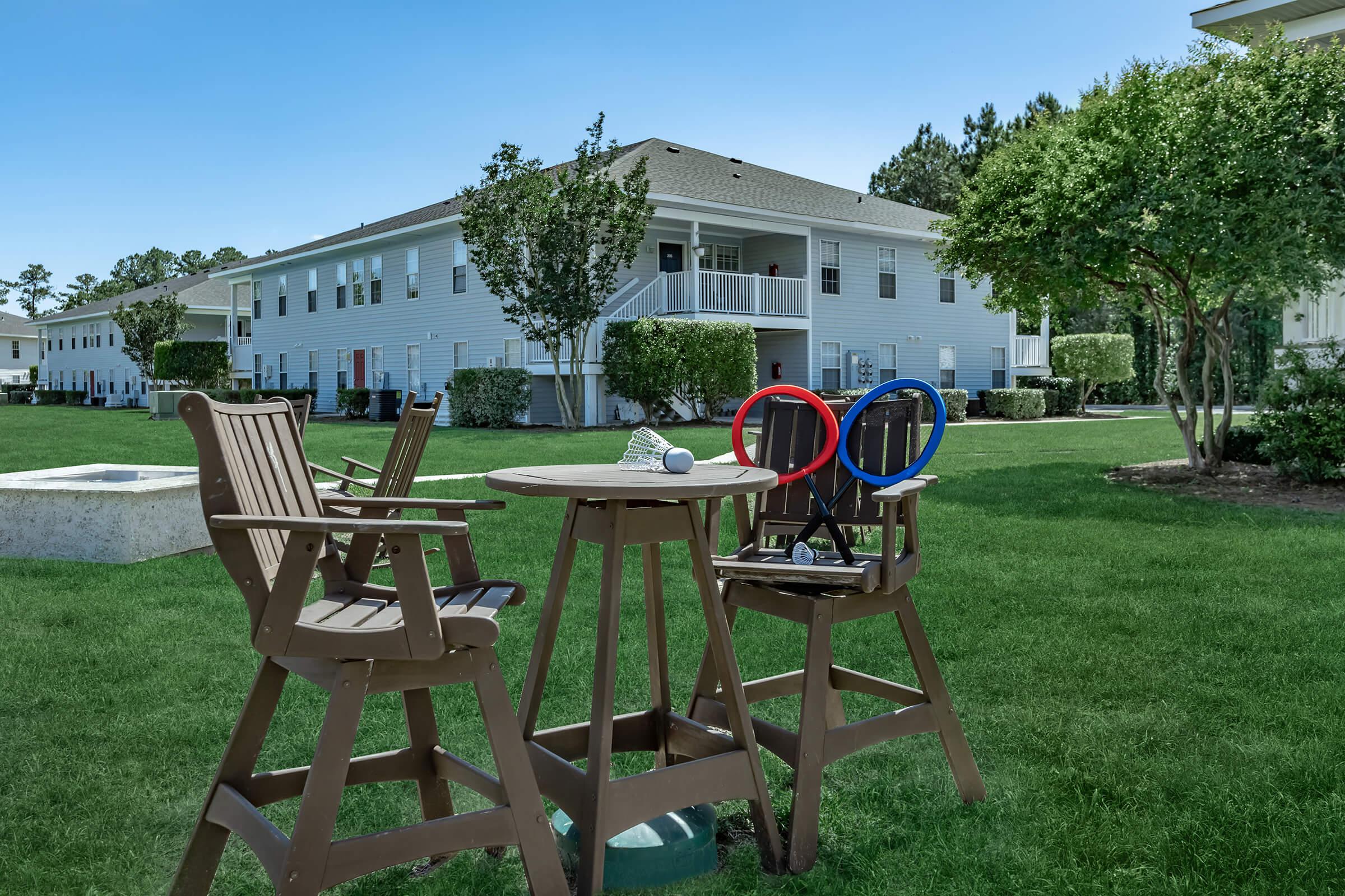 a couple of lawn chairs sitting on top of a picnic table