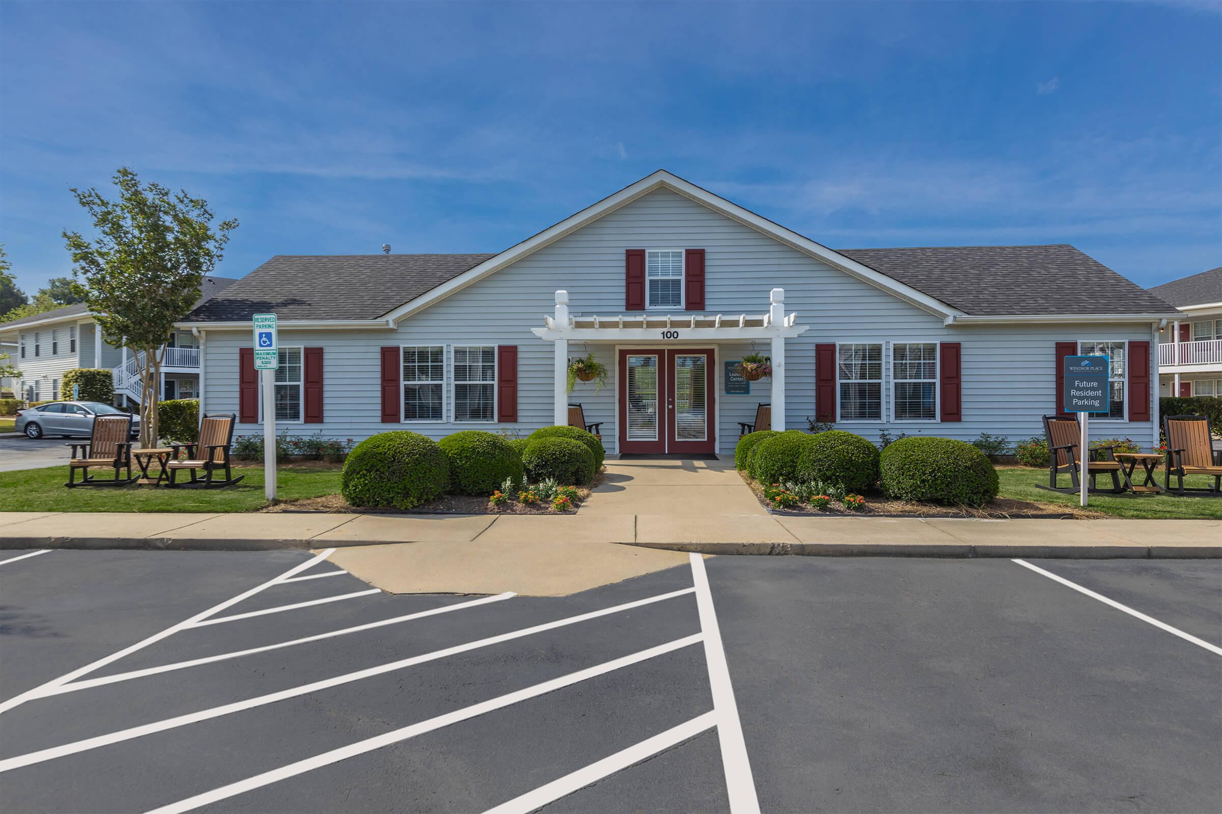 an empty parking lot in front of a house