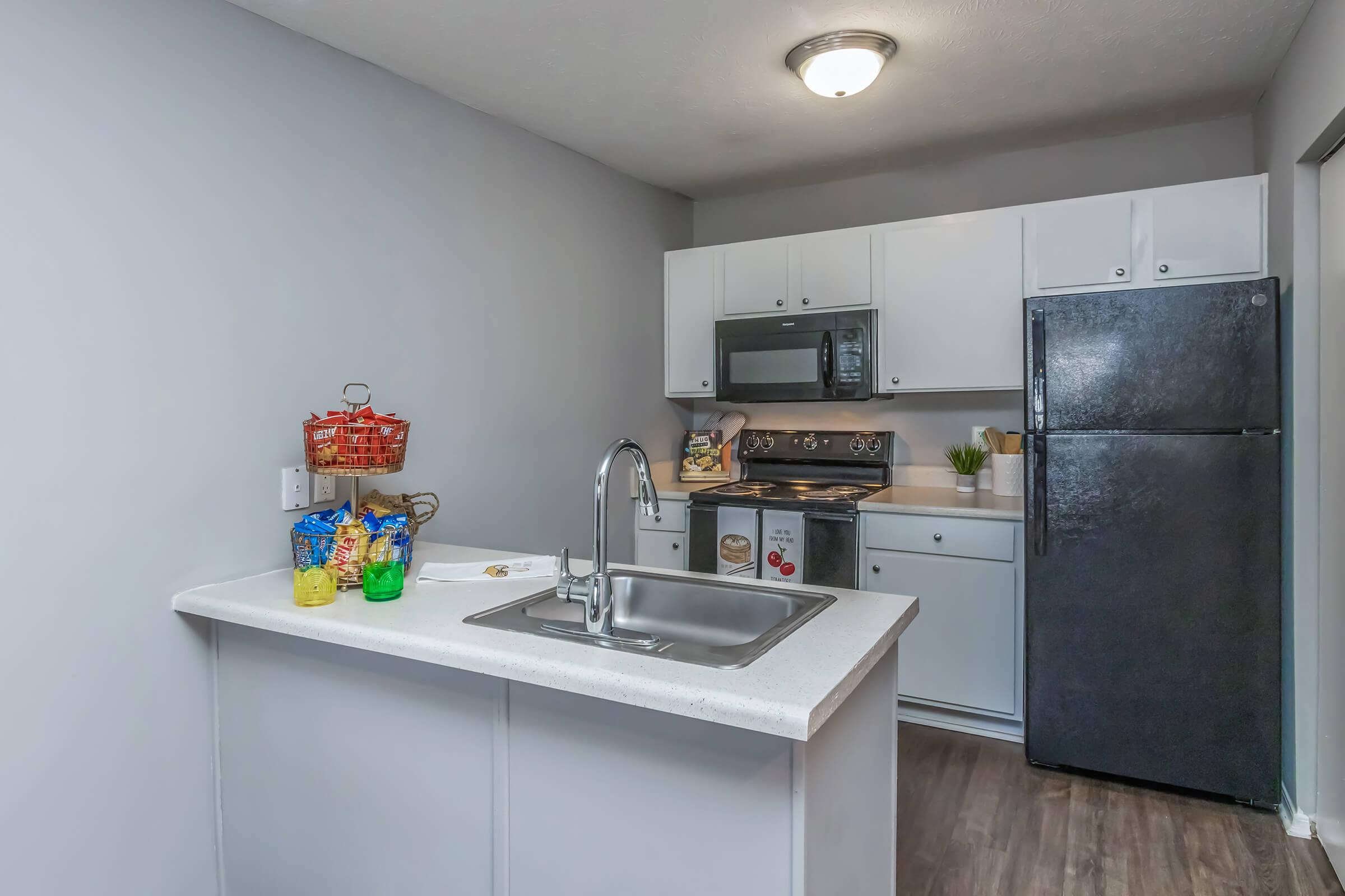 a kitchen with a sink and a refrigerator