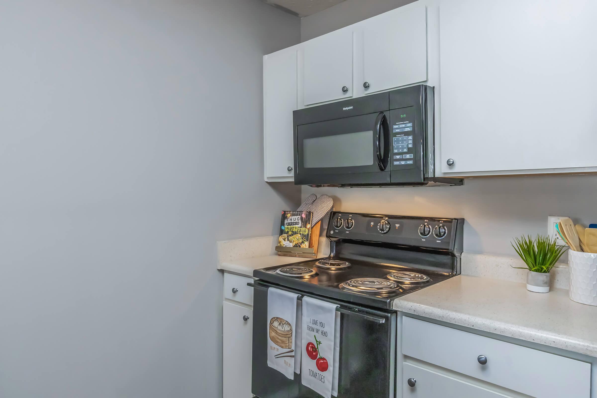 a kitchen with a stove a sink and a microwave