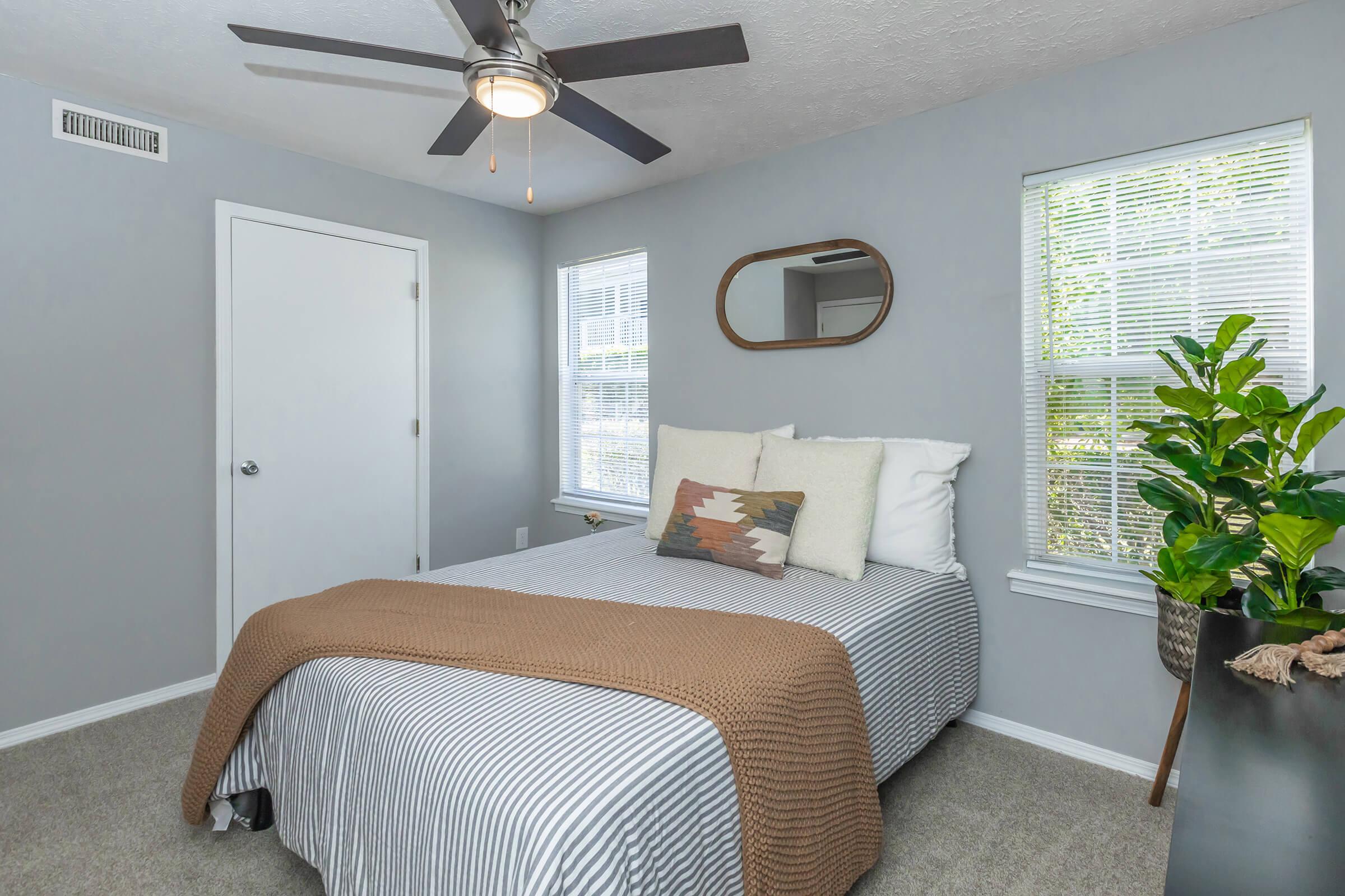 a bedroom with a bed and desk in a room