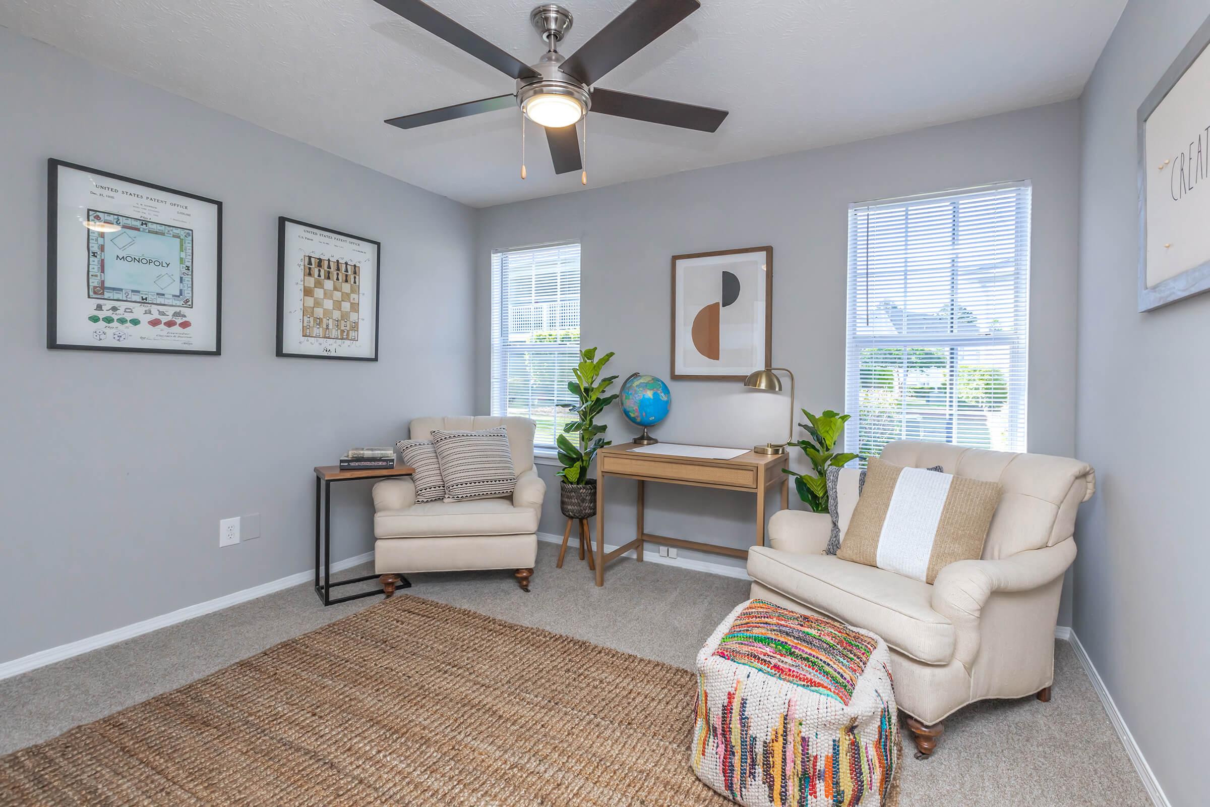 a living room filled with furniture and a large window