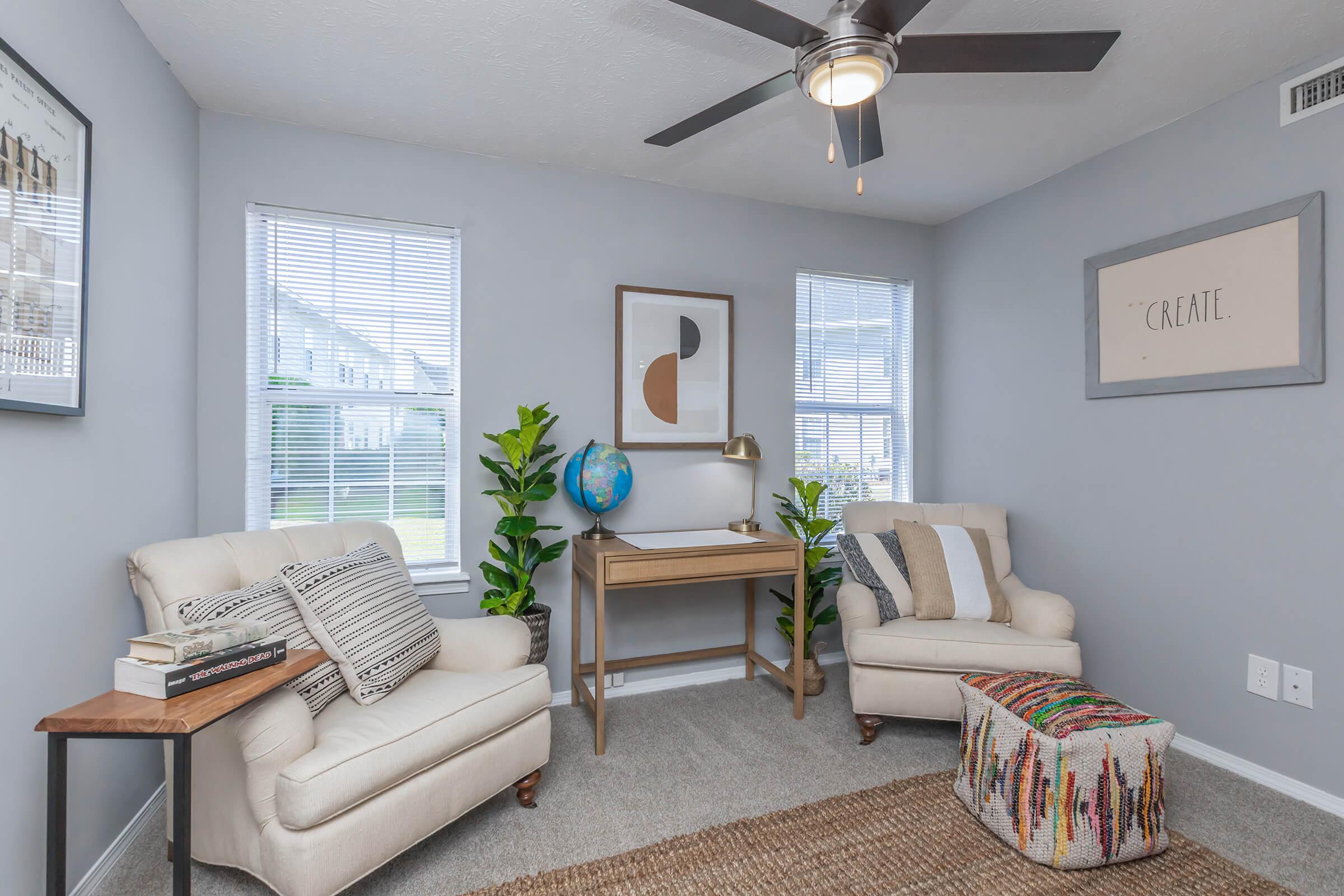 a living room filled with furniture and a large window