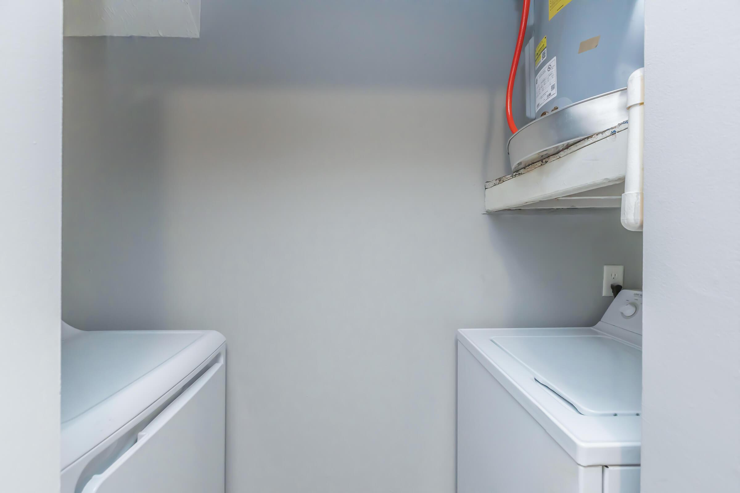 a microwave oven sitting on top of a refrigerator