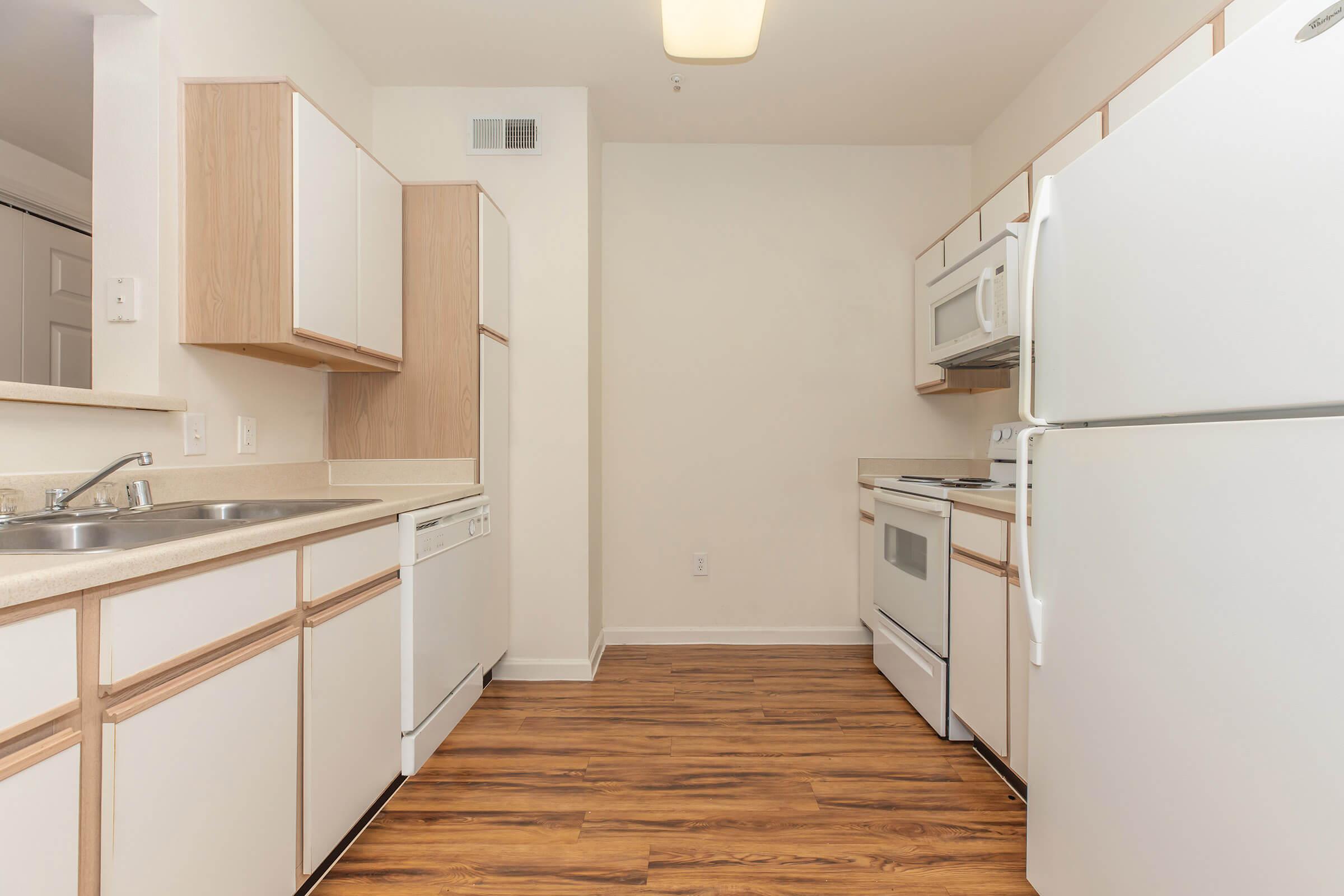 a kitchen with a sink and a refrigerator