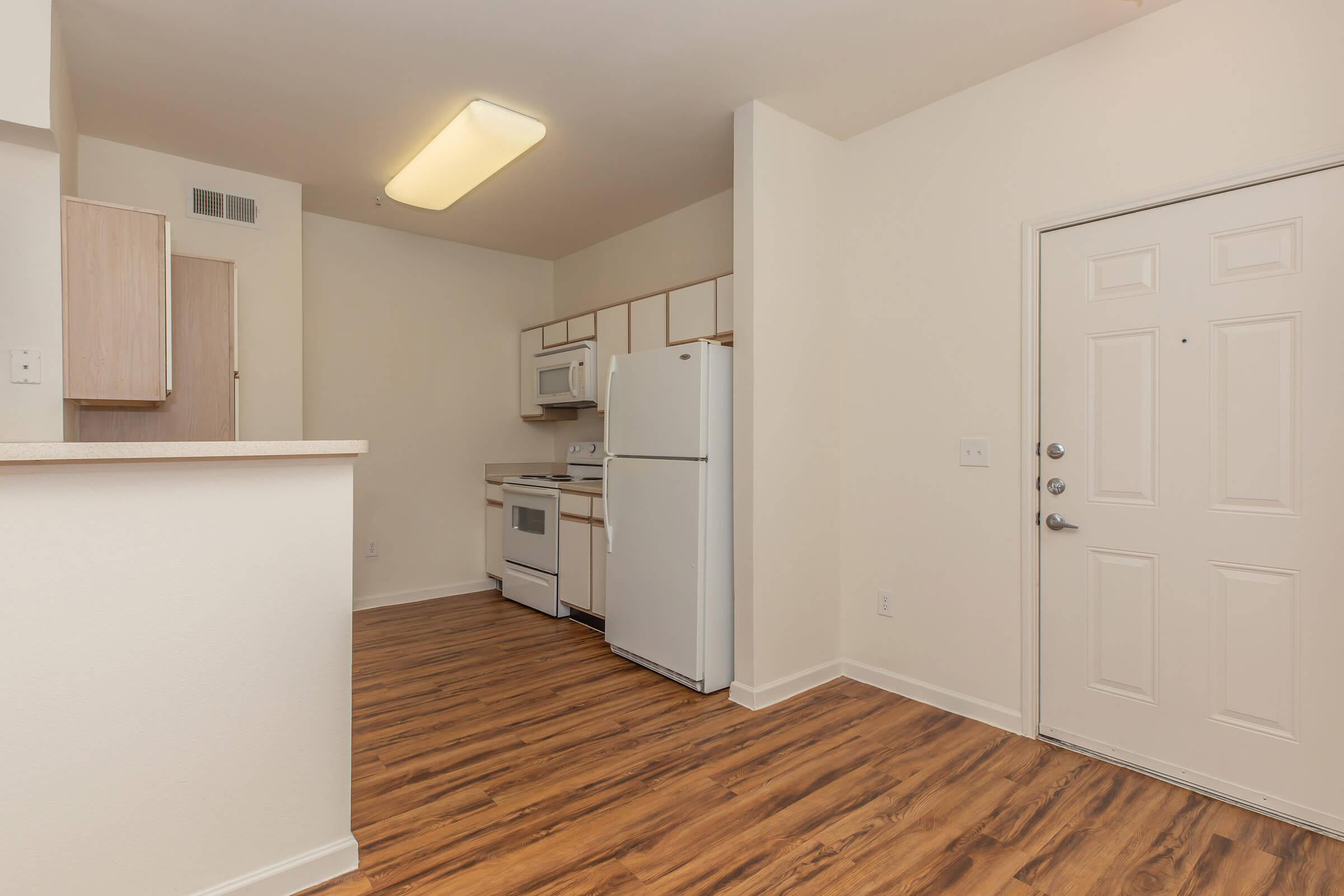 a kitchen with a stove and a refrigerator