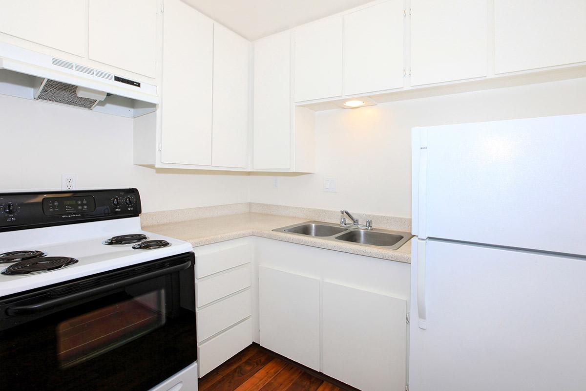 a white stove top oven sitting inside of a kitchen