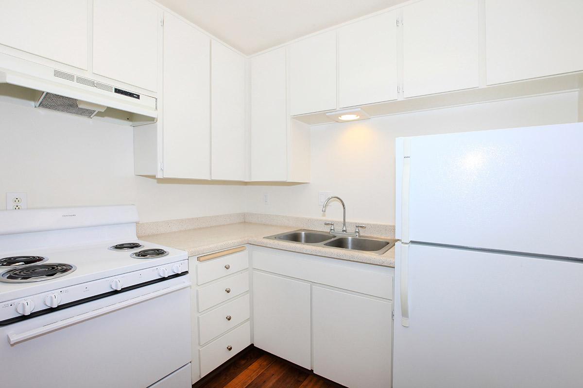 a white stove top oven sitting inside of a kitchen