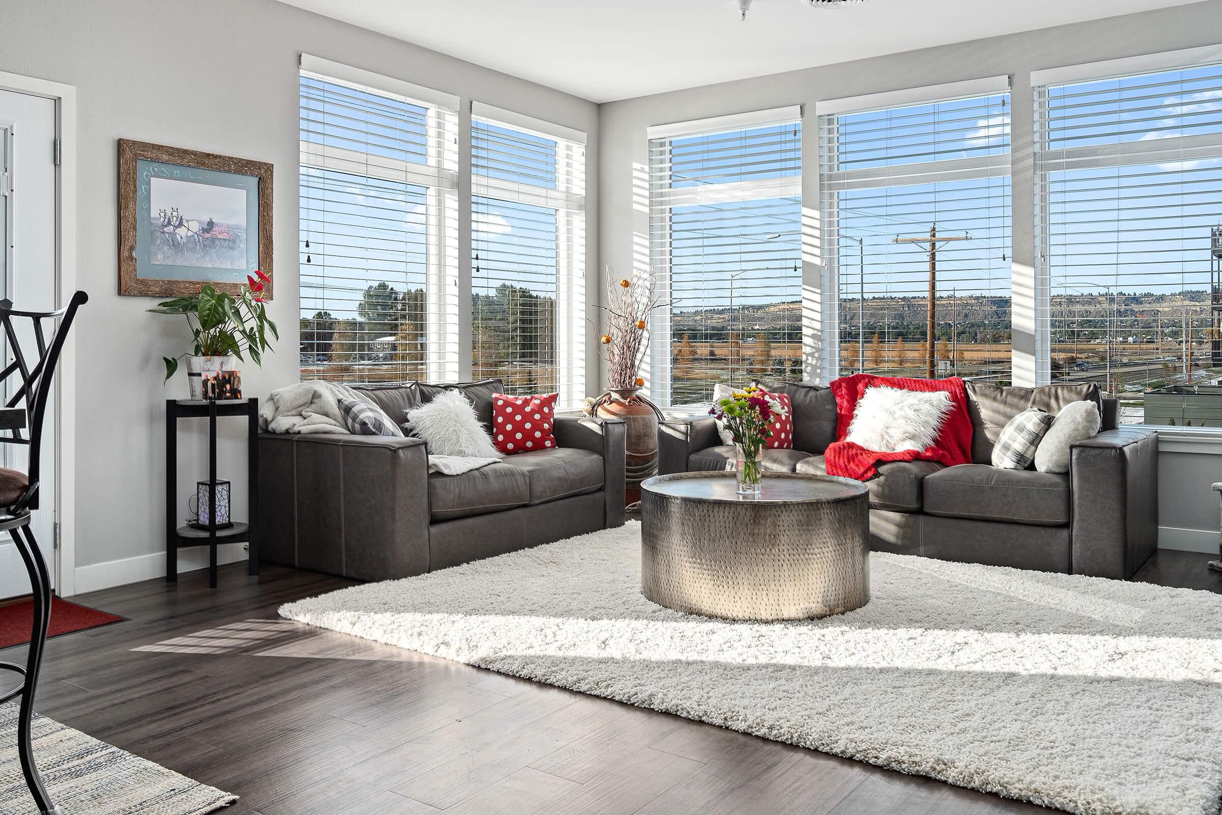 a living room filled with furniture and a large window