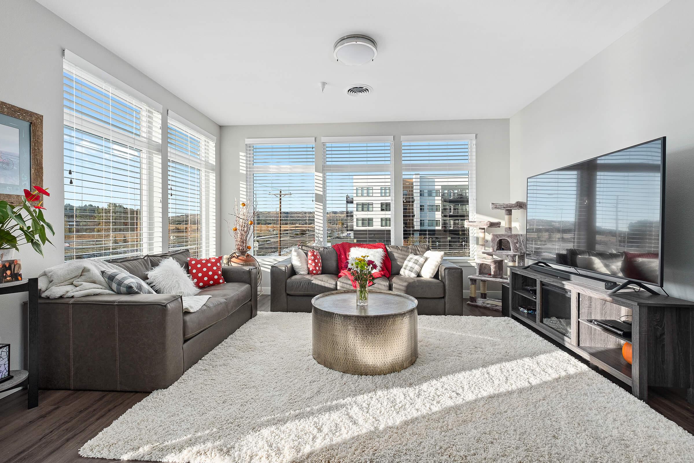 a living room filled with furniture and a large window