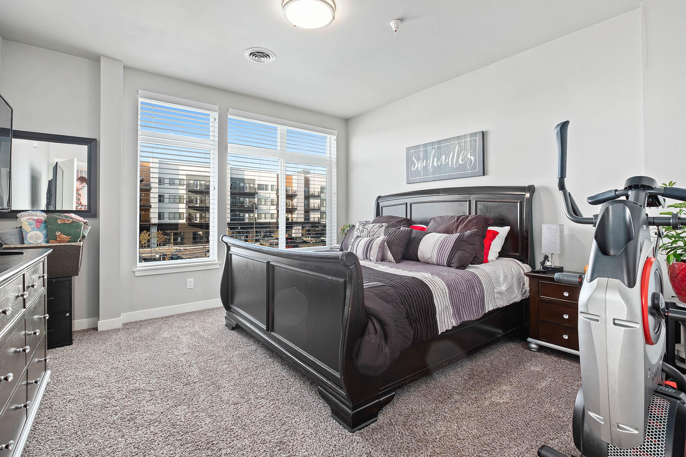 a living room filled with furniture and a large window