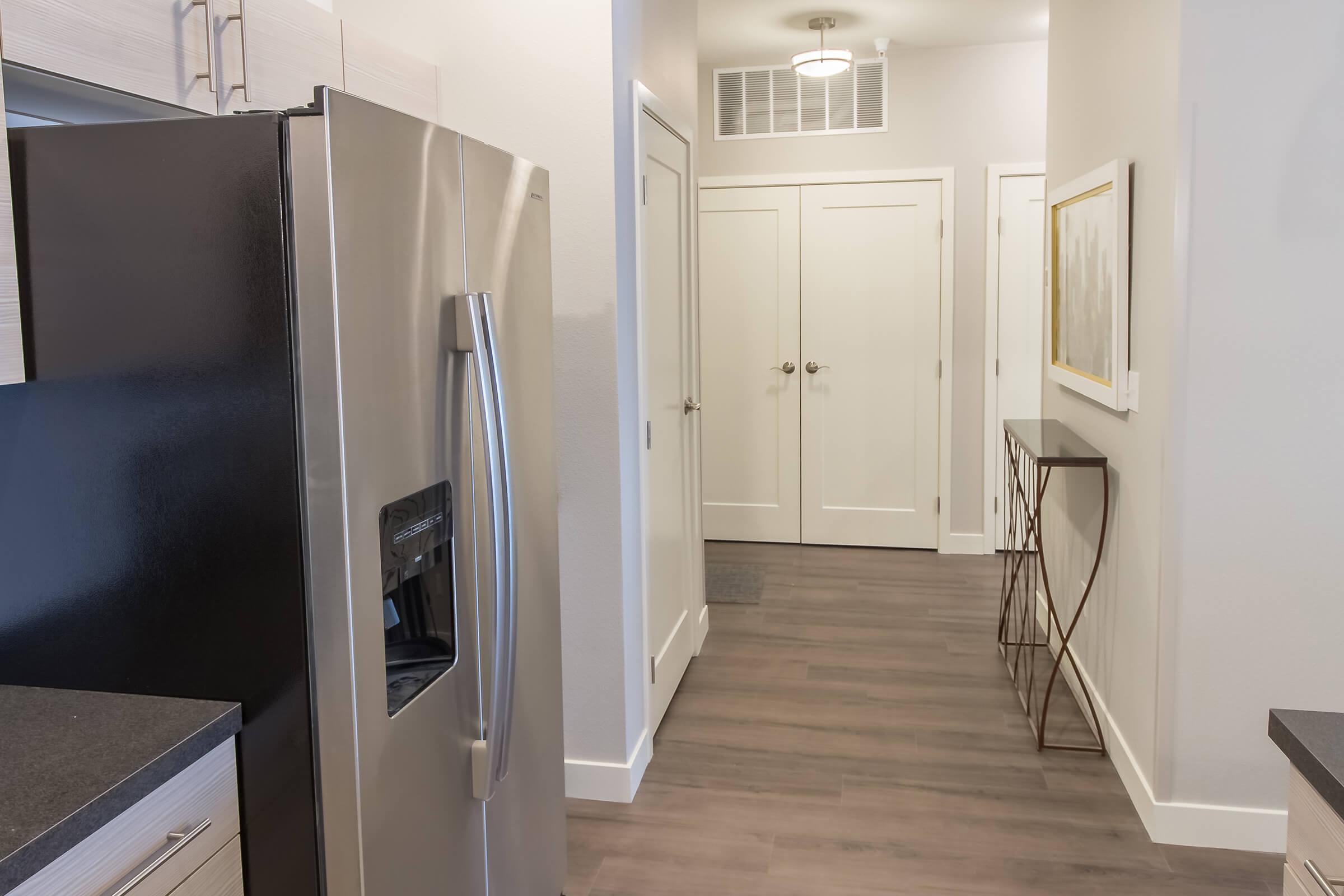 a stainless steel refrigerator in a small room