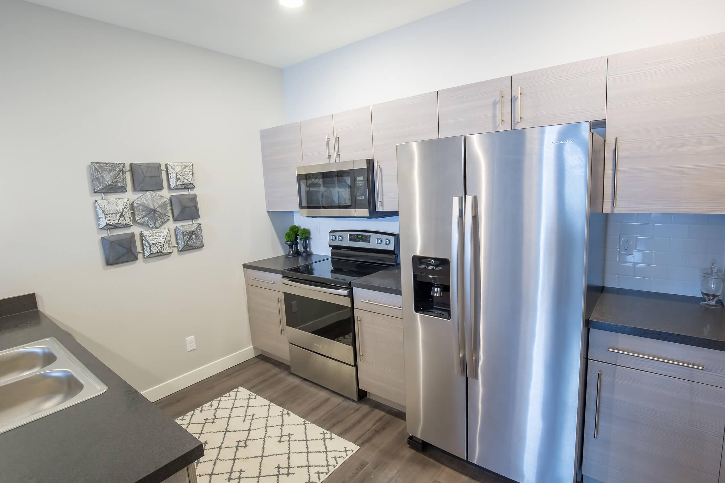 a kitchen with a stove and a refrigerator