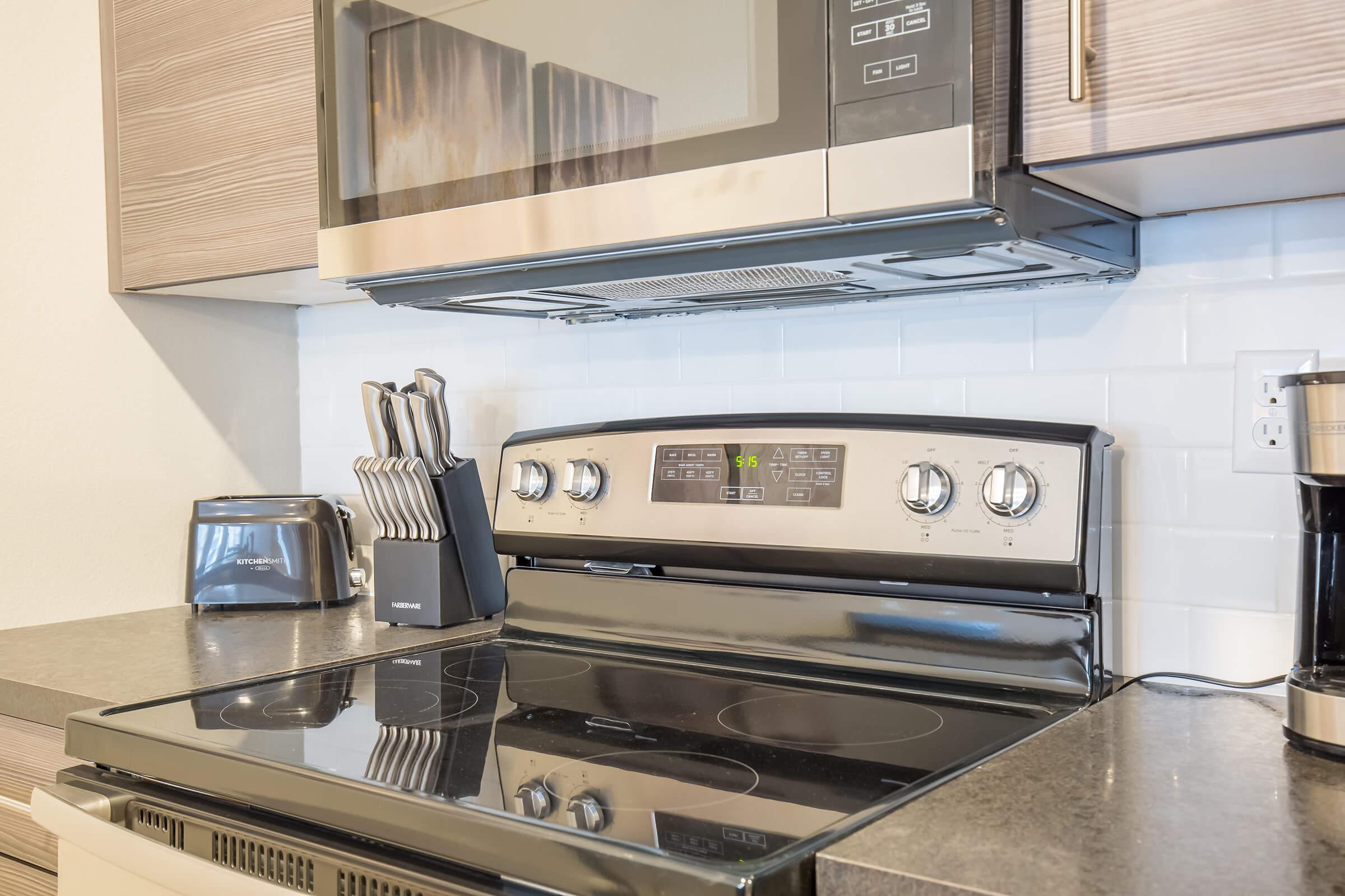 a stove top oven sitting inside of a kitchen