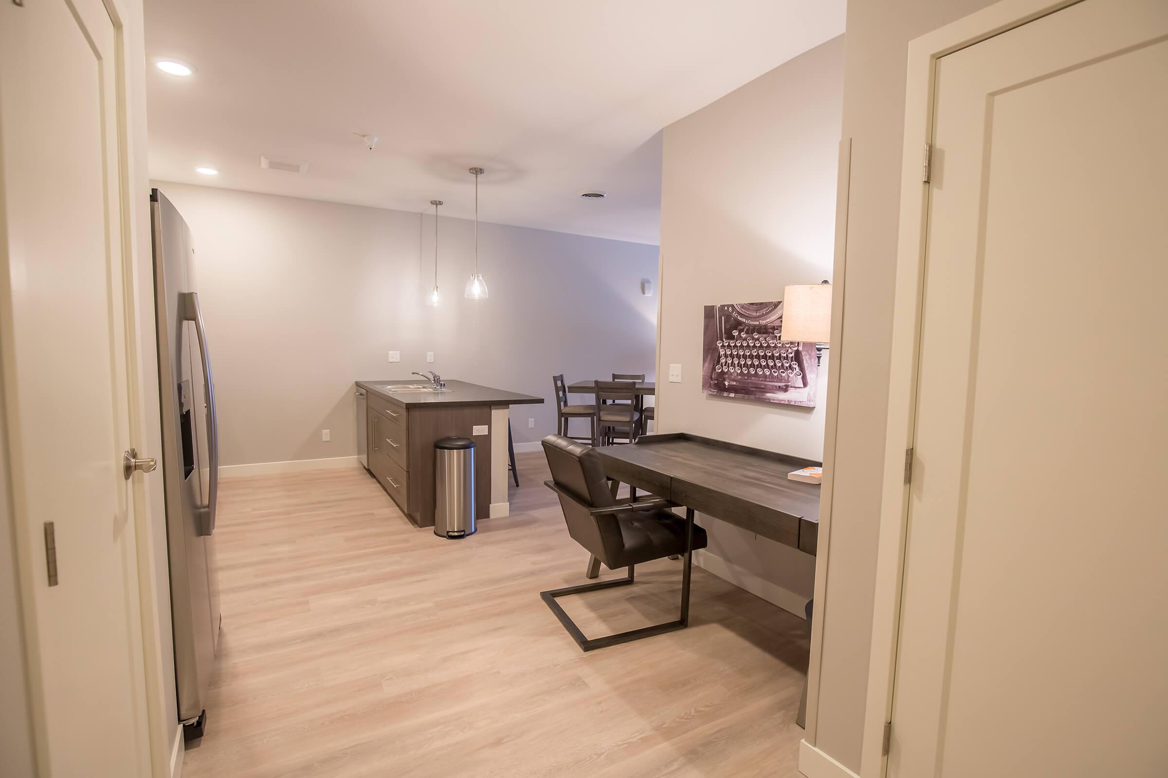 a kitchen with a wood floor in a room