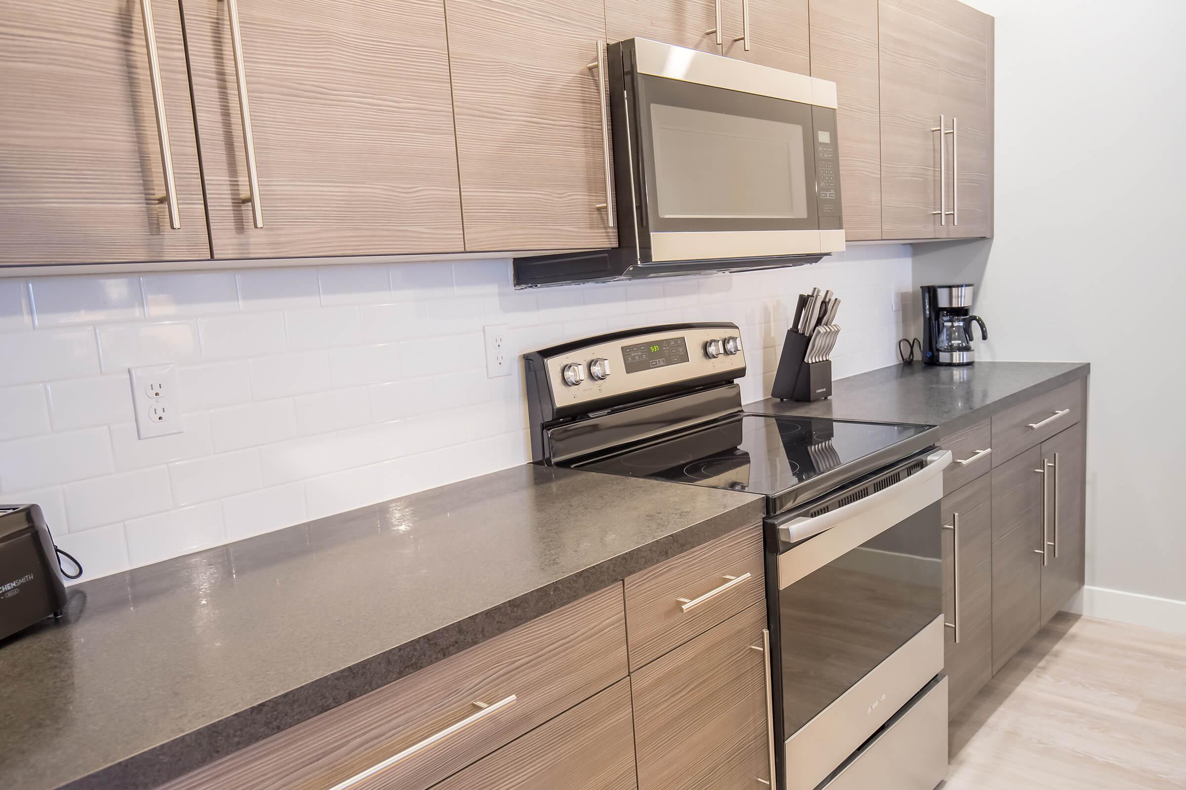 a stove top oven sitting inside of a kitchen