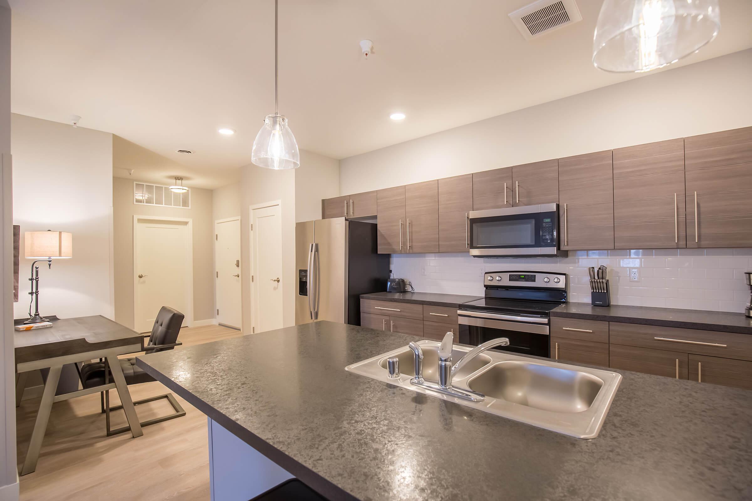 a modern kitchen with an island in the middle of a room