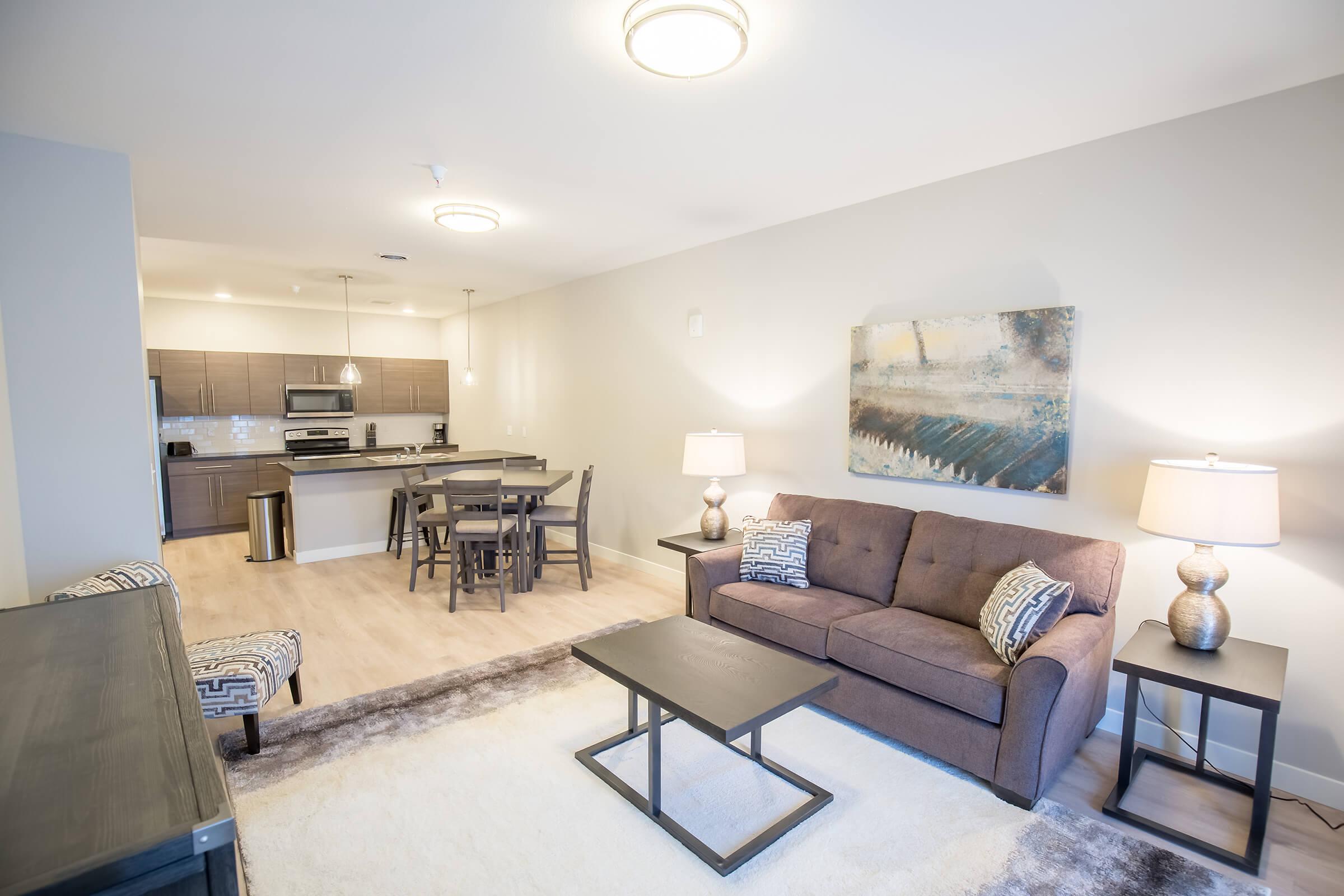 a living room filled with furniture and a table