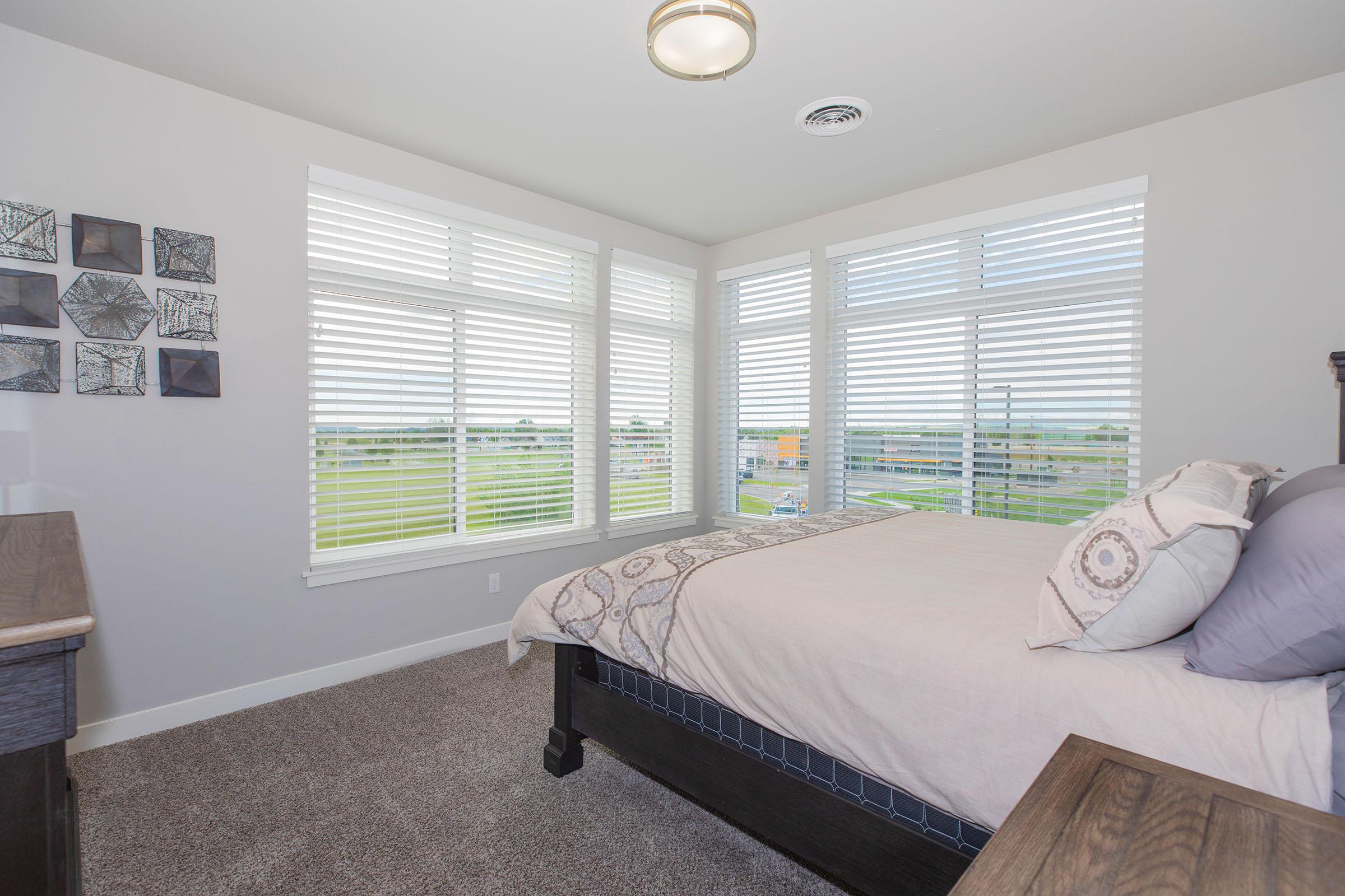 a living room with a bed and a window