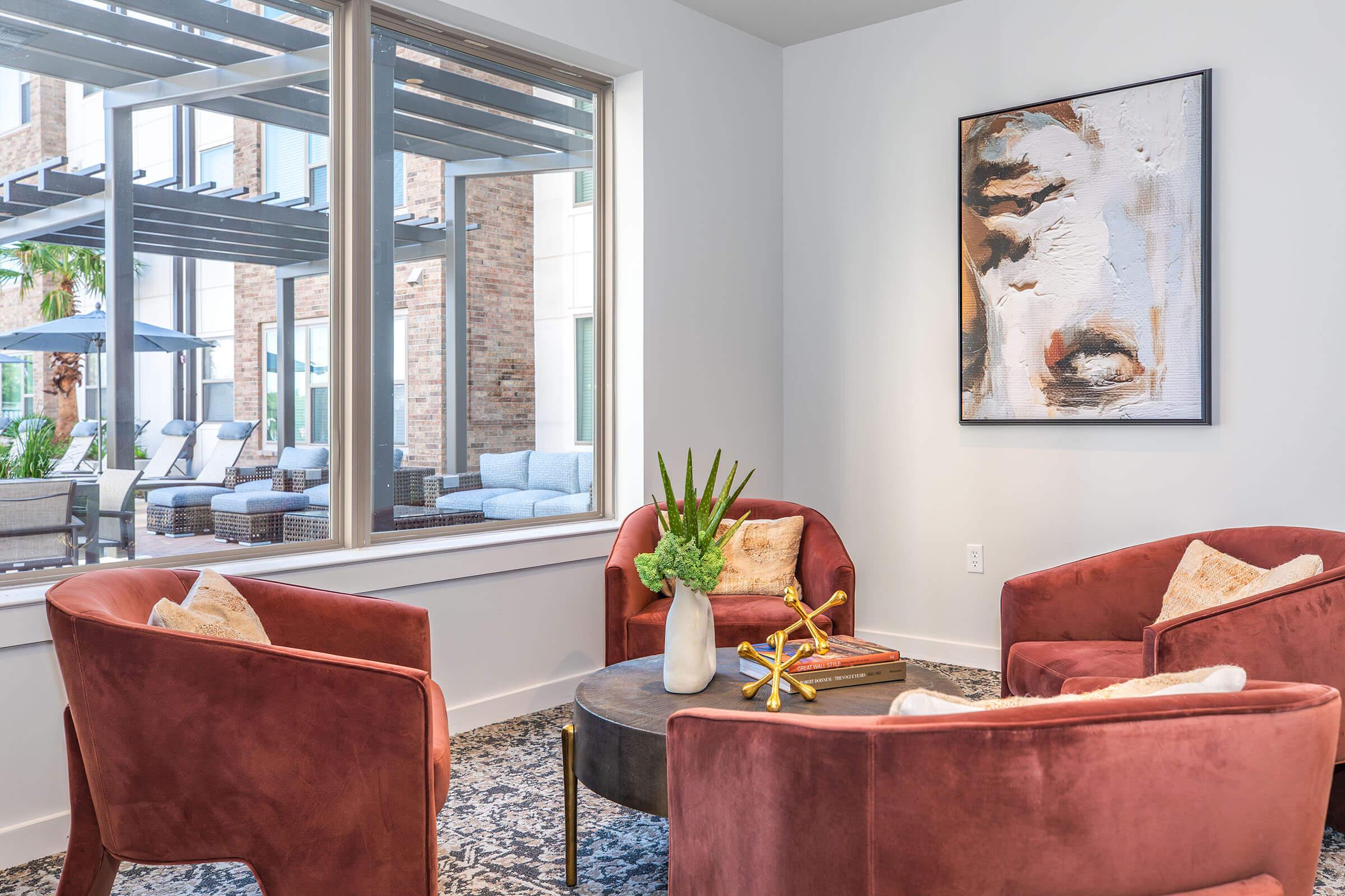 a living room filled with furniture and a large window