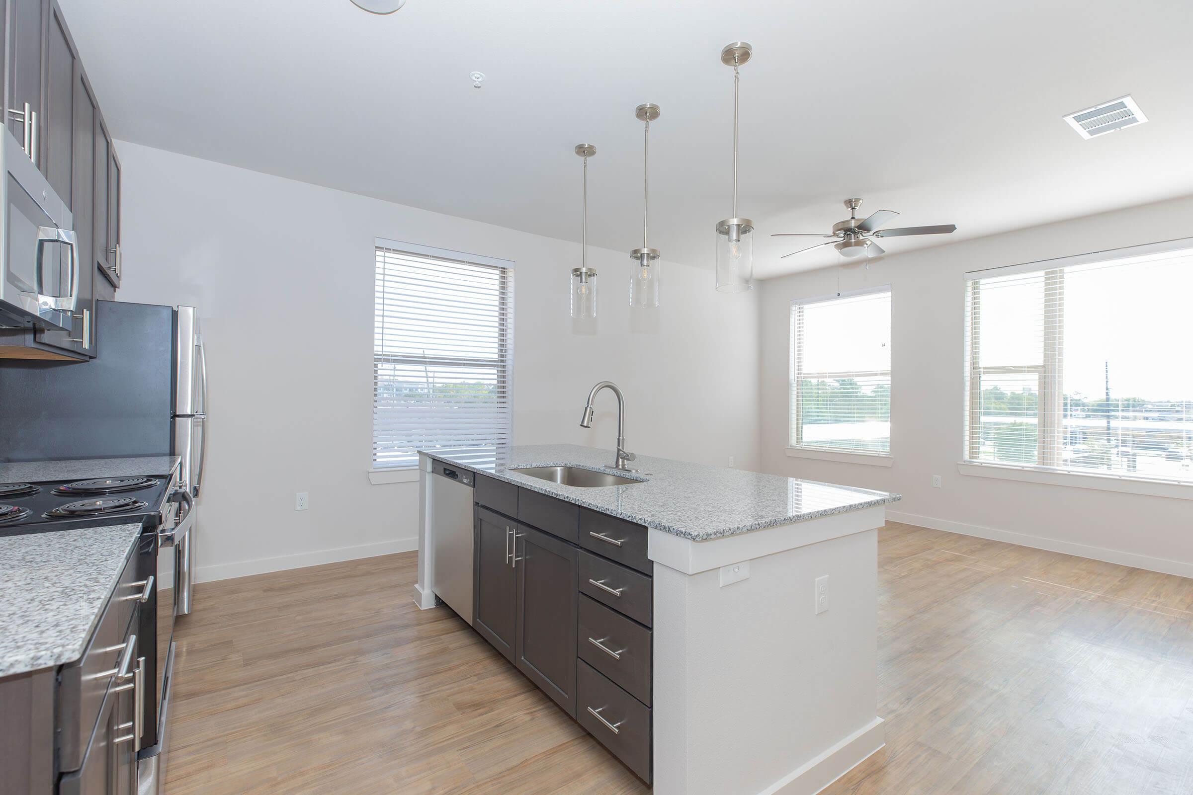 a kitchen with an island in the middle of a room