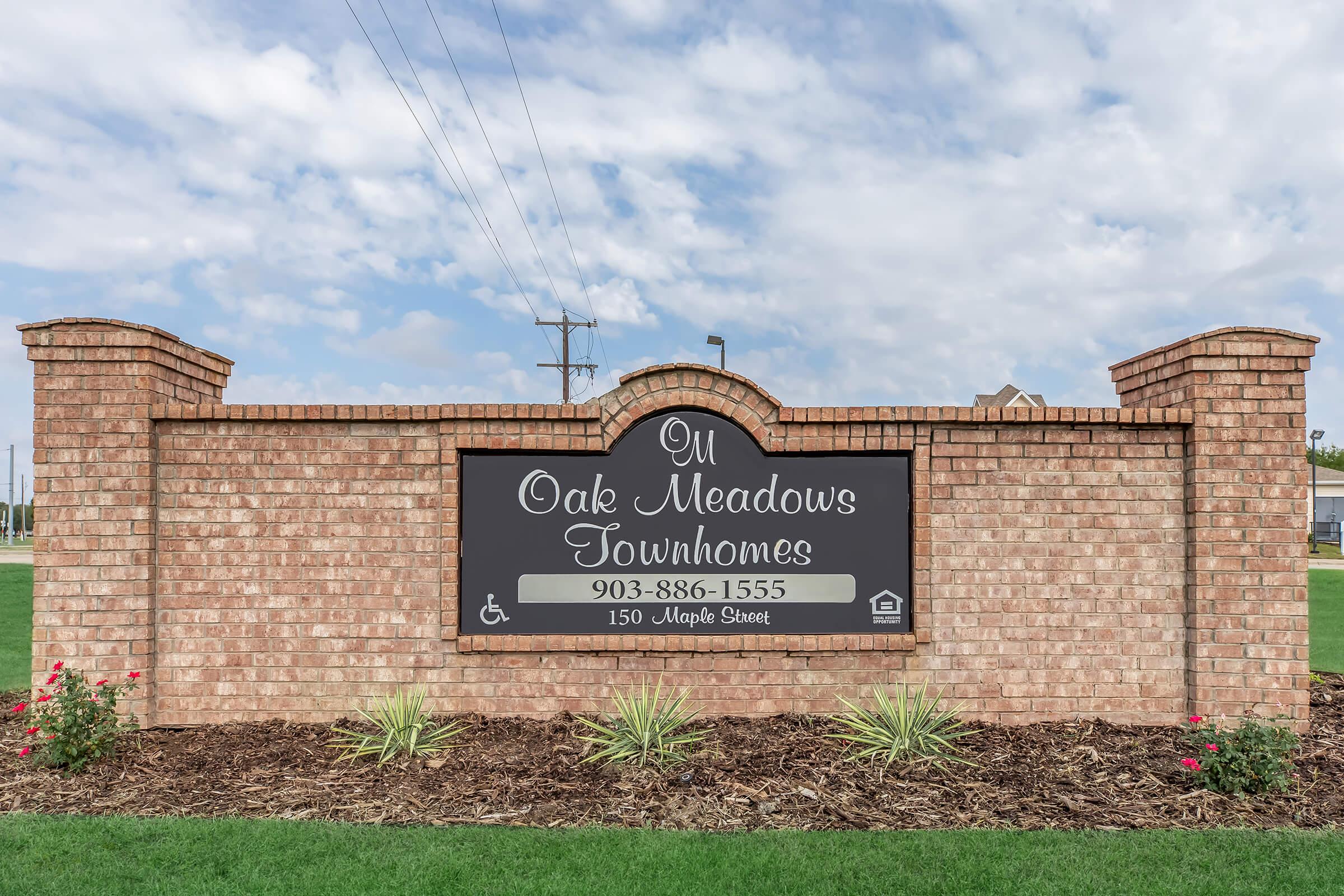 a sign in front of a brick building