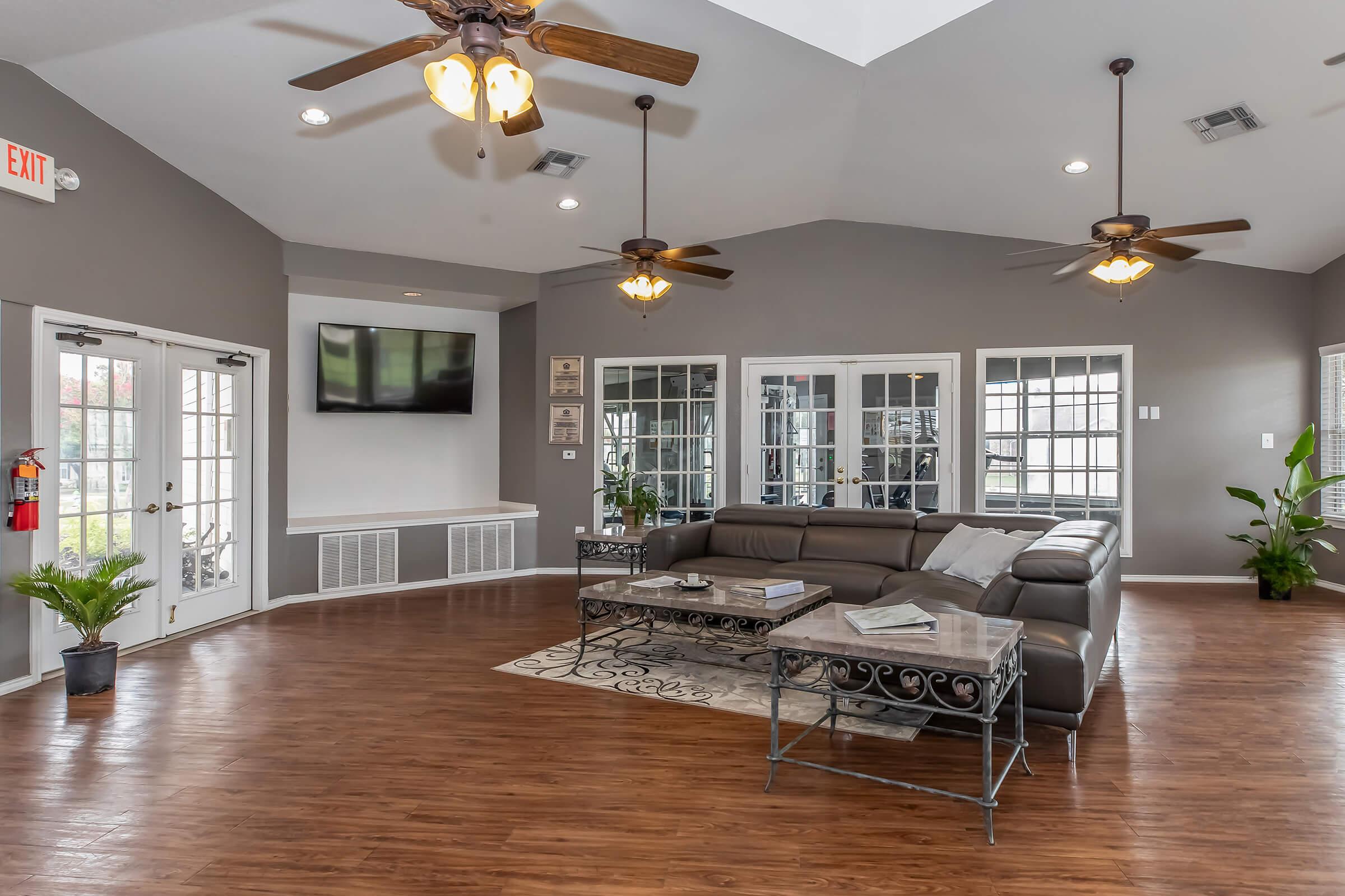 a living room filled with furniture and a large window