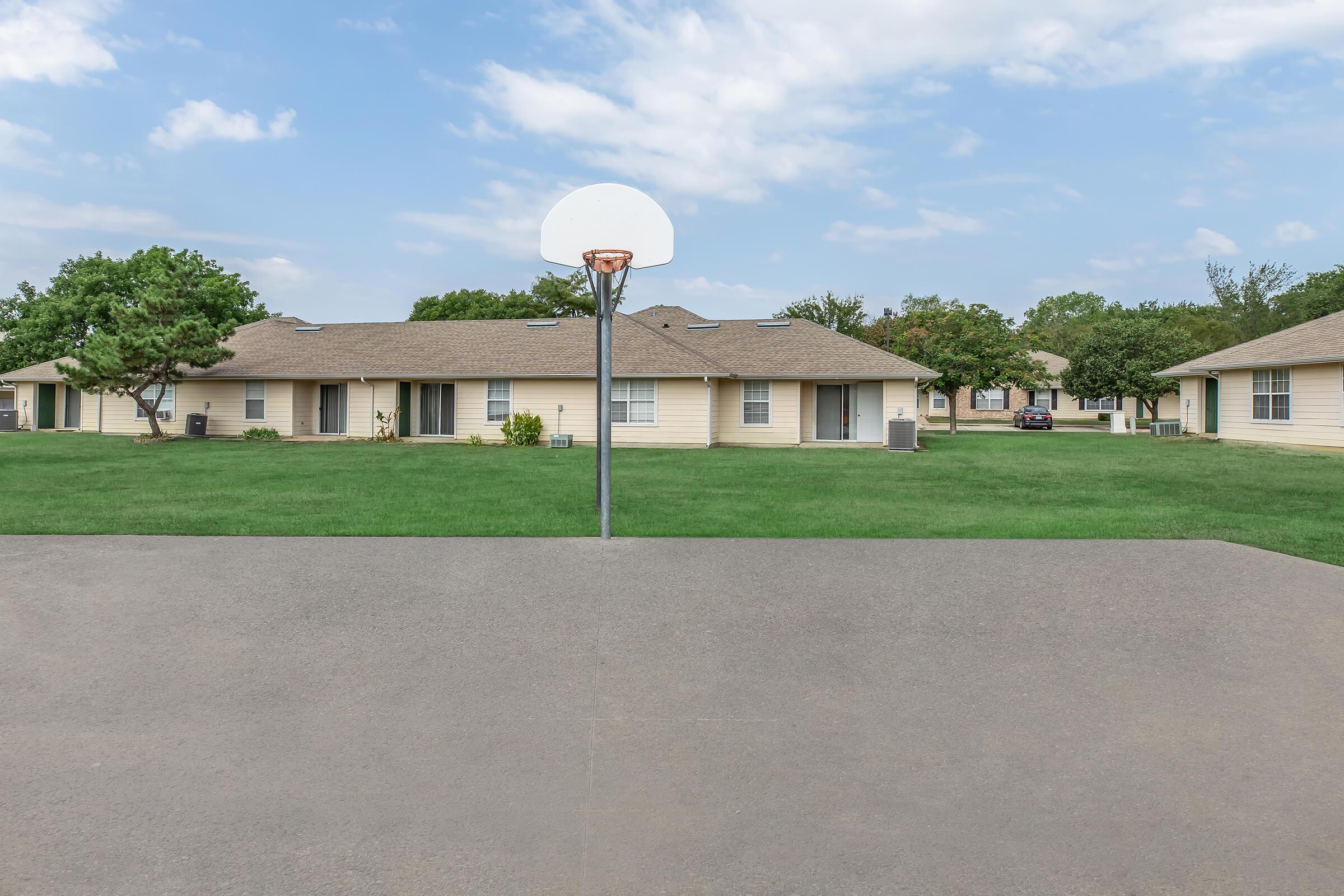 a house that has a sign on the side of a road